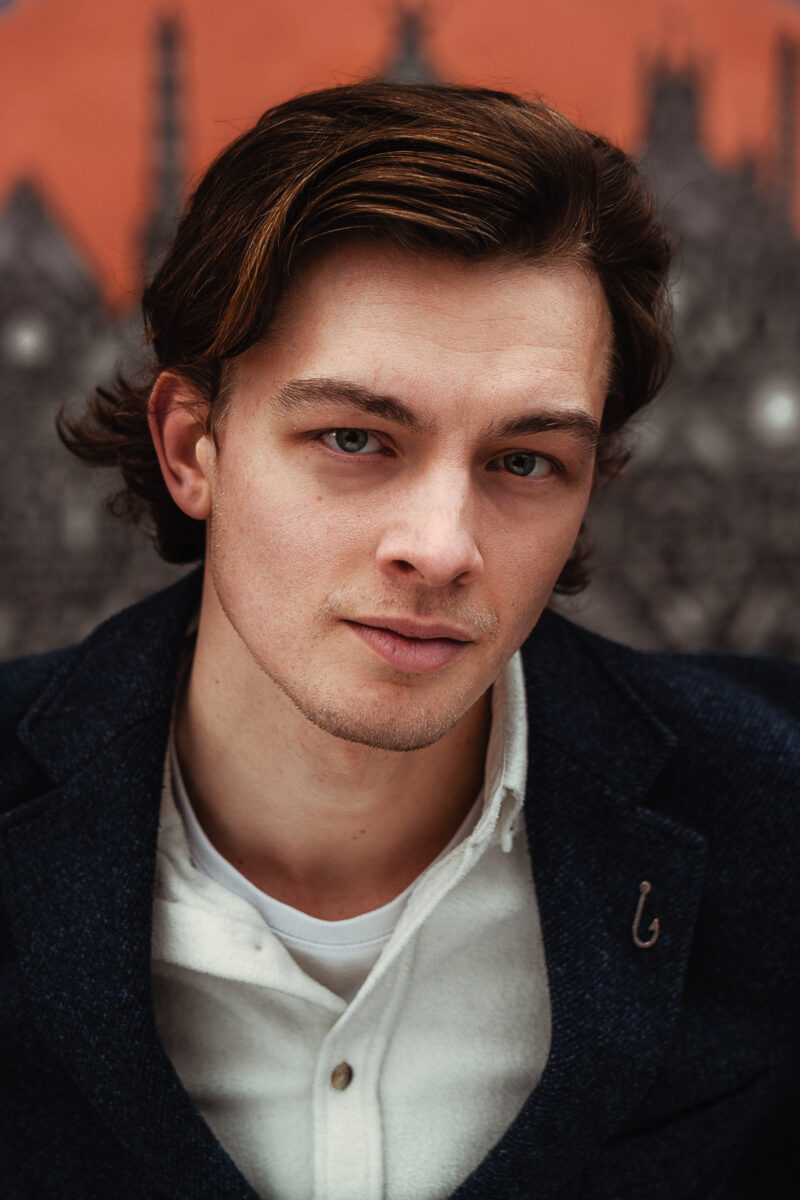Portrait of a young man outside on a cloudy day