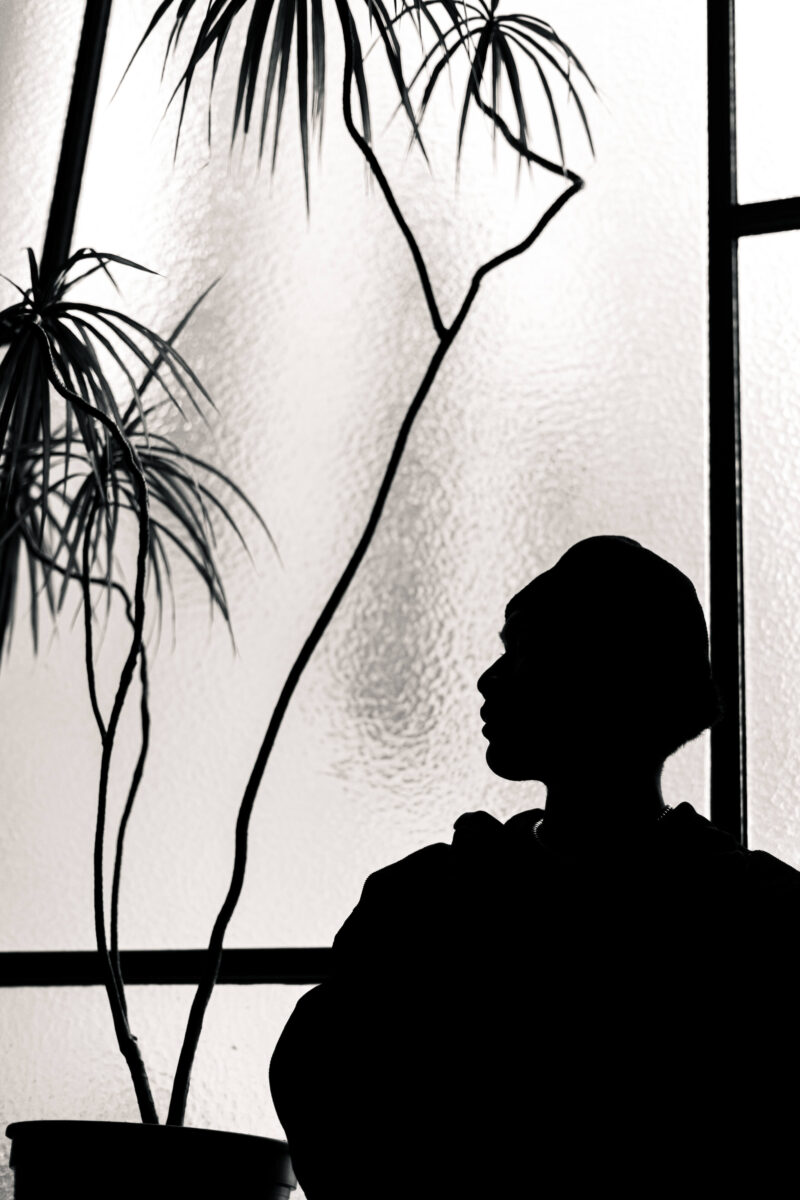 black and white photography silhouette of a man in front of a window.
Photographer's self-esteem.