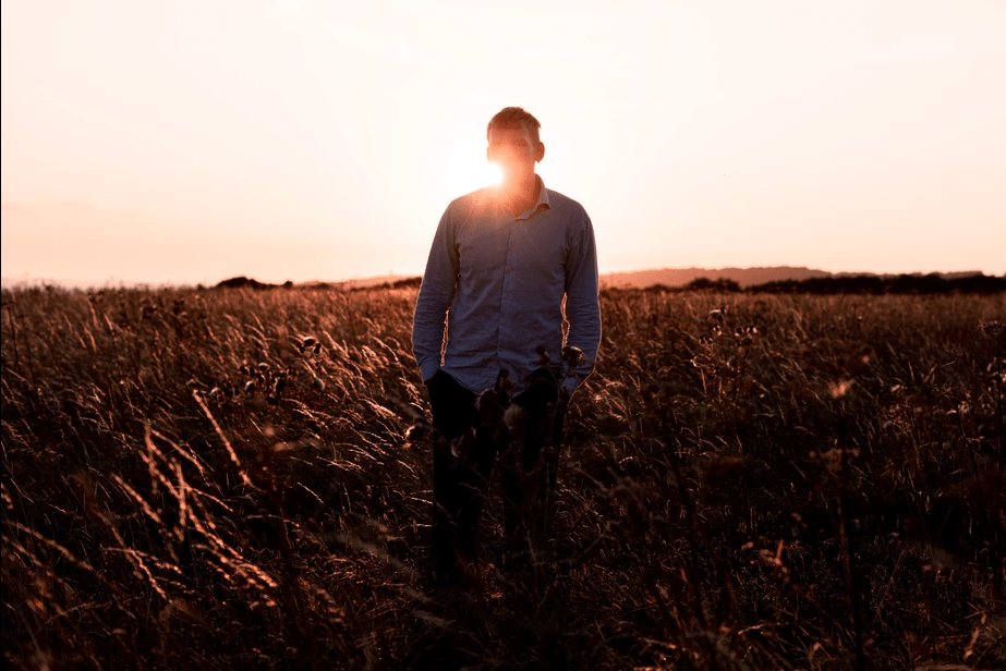 10 Best Ways To Improve Photography Skills. Fedor Vasilev Photographer In Berlin Photographer Fedor Vasilev standing in a field at sunset for a tutorial "Improve photography skills"