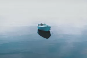 Contrast in photography. A low contrast image of a boat on calm water