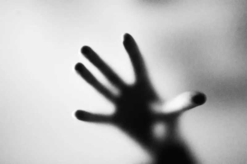 Blurred photo of hand on a glass