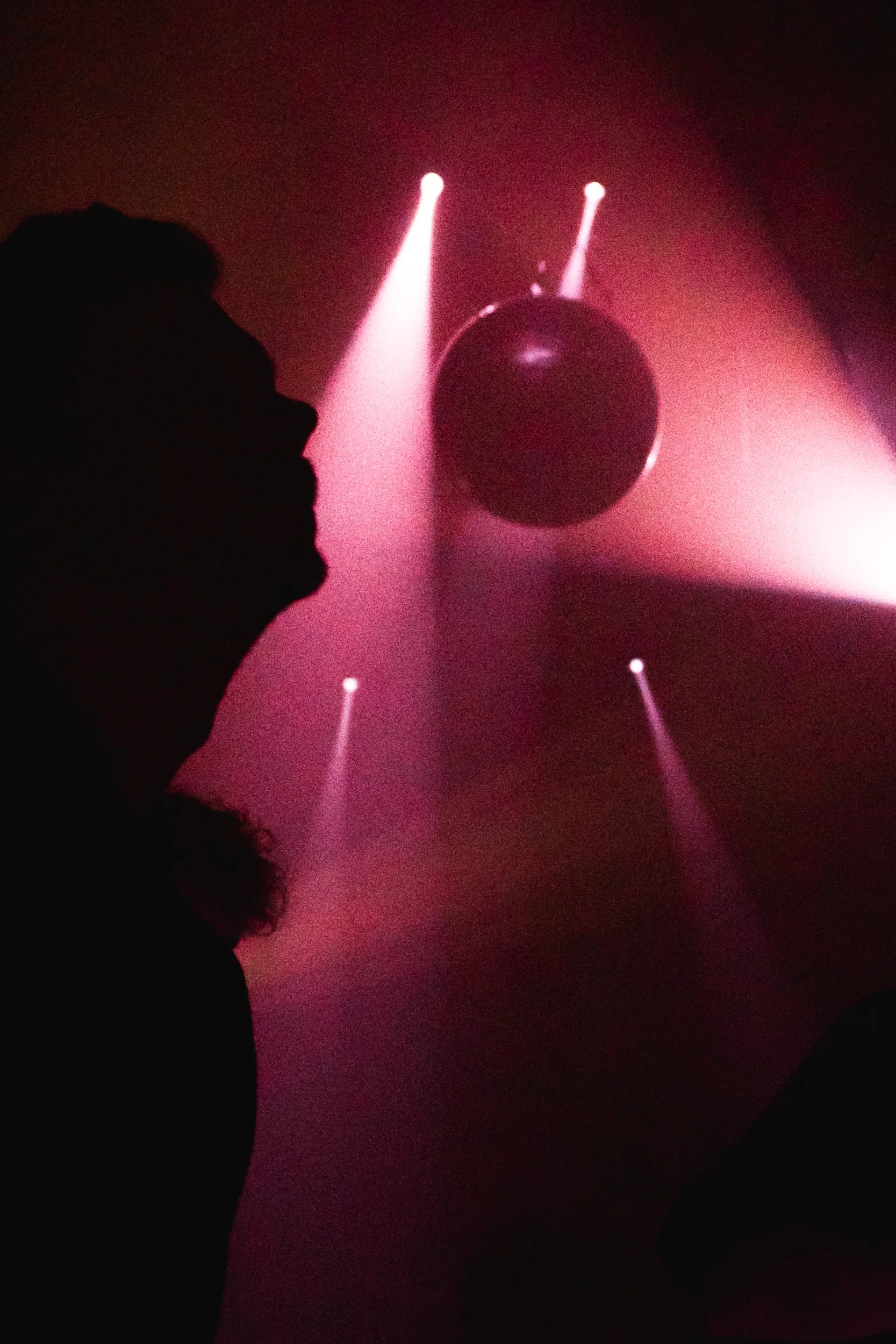 Silhouette of a man on a party with red lights