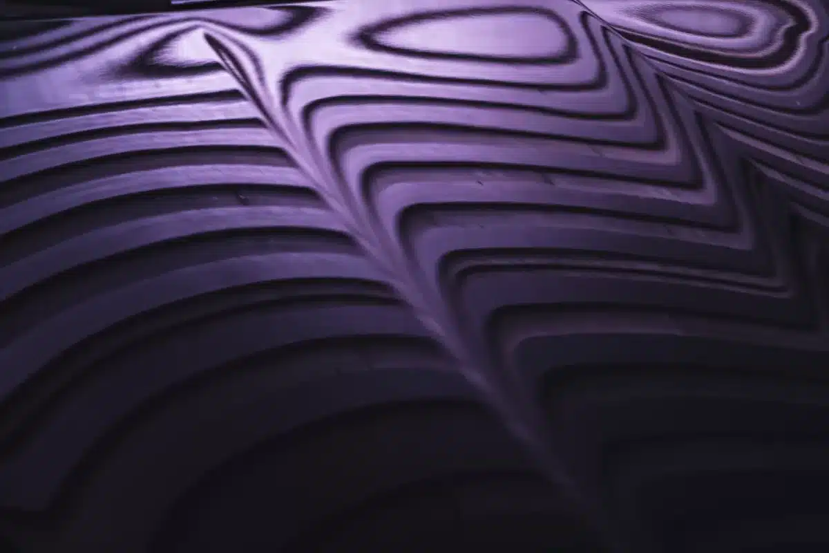 A photograph of an abstract reflection in a hood of a car