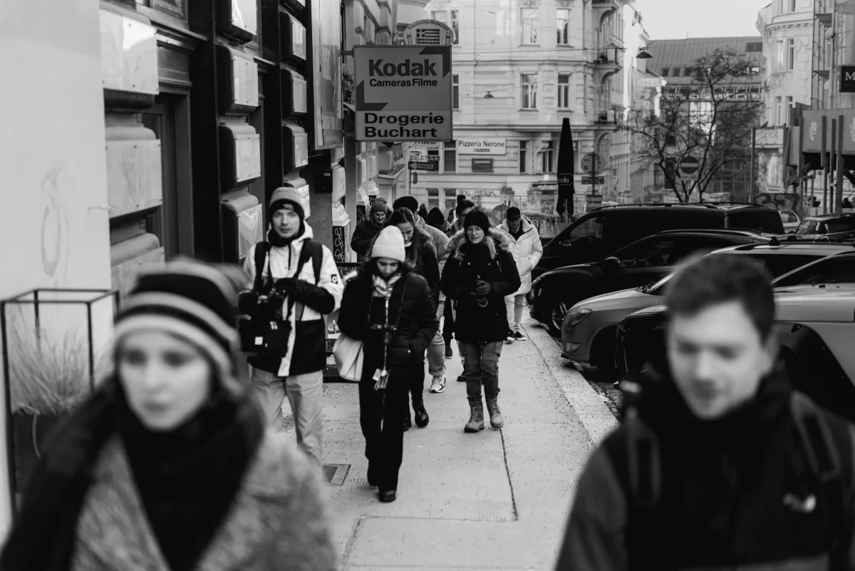 Photowalk in Vienna a black and white photo of our group walking on a street