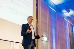 Corporate Photography in Berlin Fedor Vasilev Photographer In Berlin Speaker on the stage during an Event by Berlin business photograher Fedor Vasilev