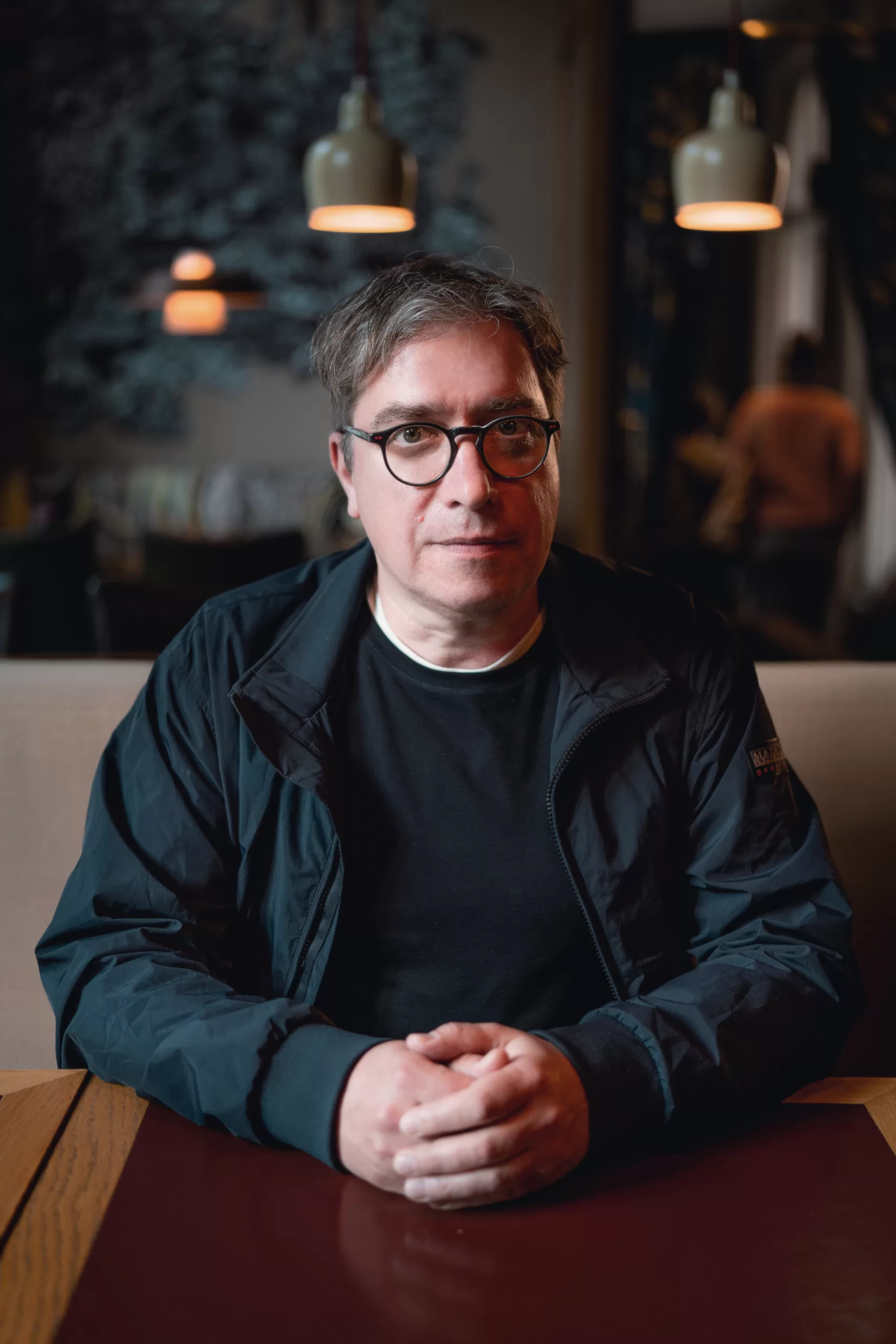 portrait of a man sitting in a cafe