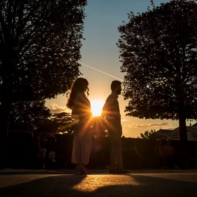 romantic photo of a couple holding hands at sunset