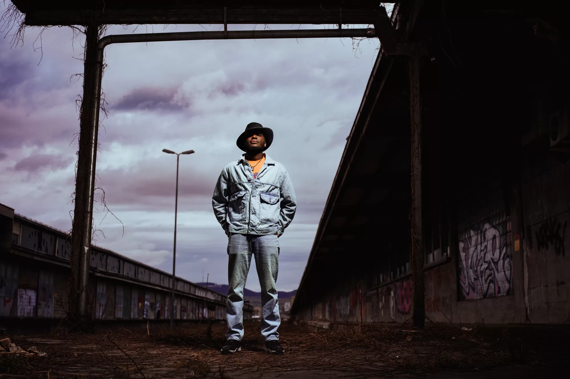 Dramatic Portrait of a man standing on an abandoned station