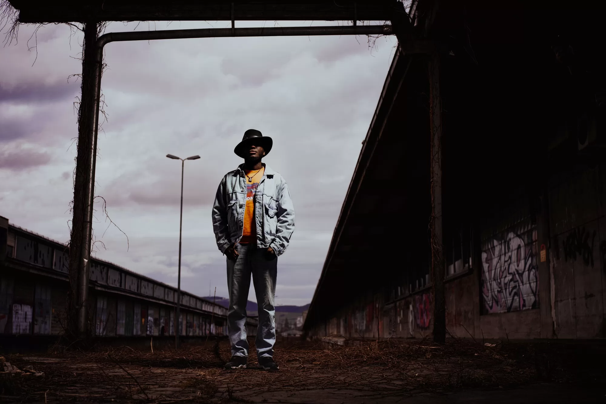 Dramatic Portrait of a man standing on an abandoned station