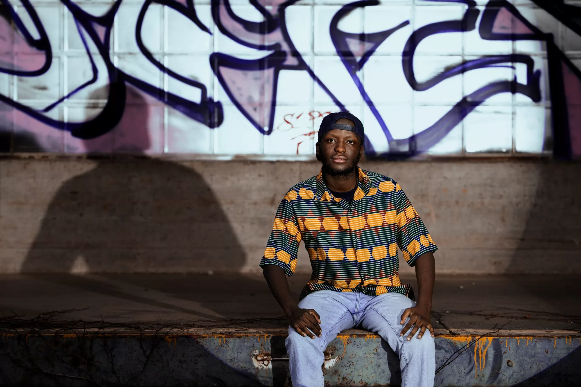 portrait of a man sitting on an abandoned train station