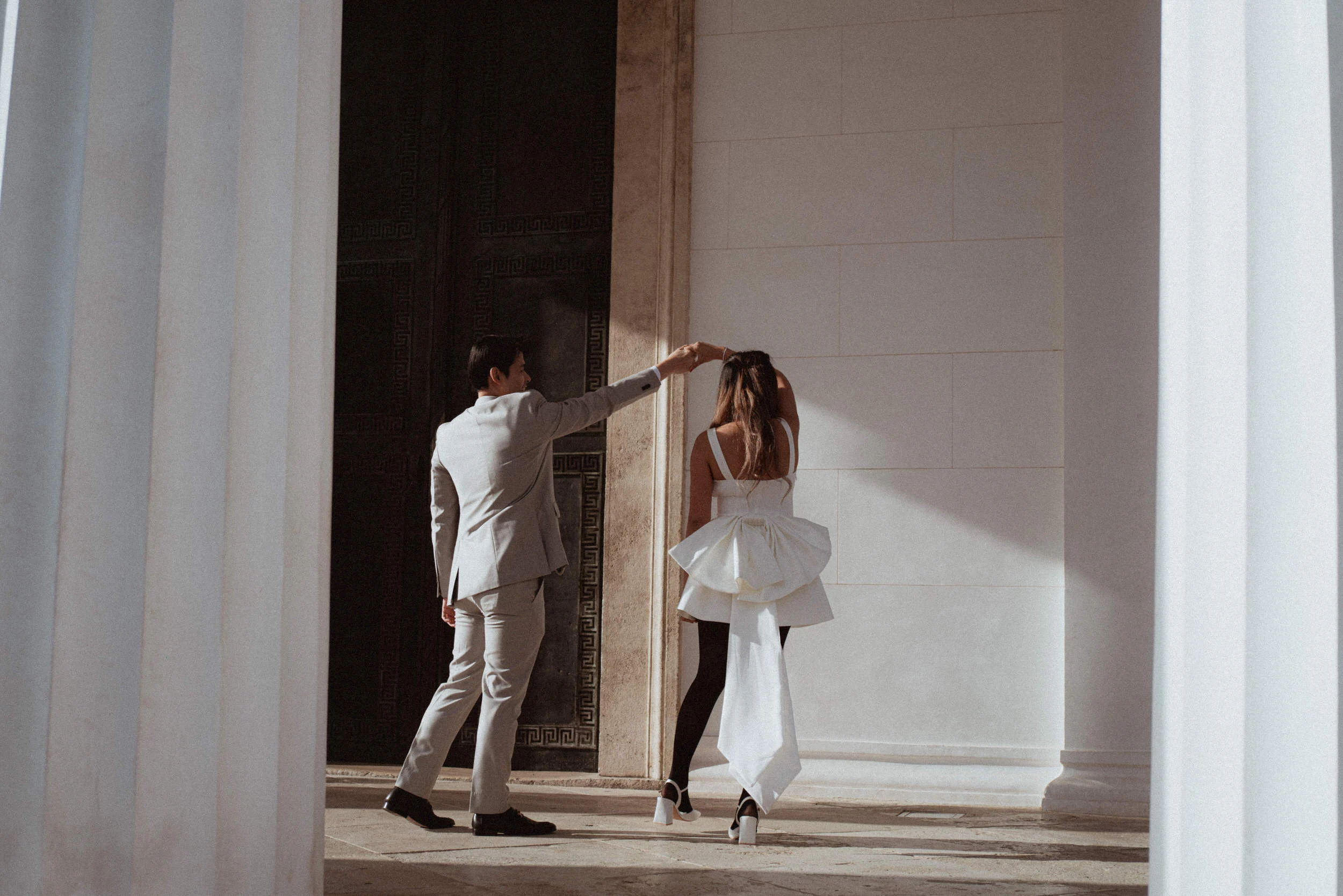 A couple dancing under coluns of Theseus Temple in Vienna