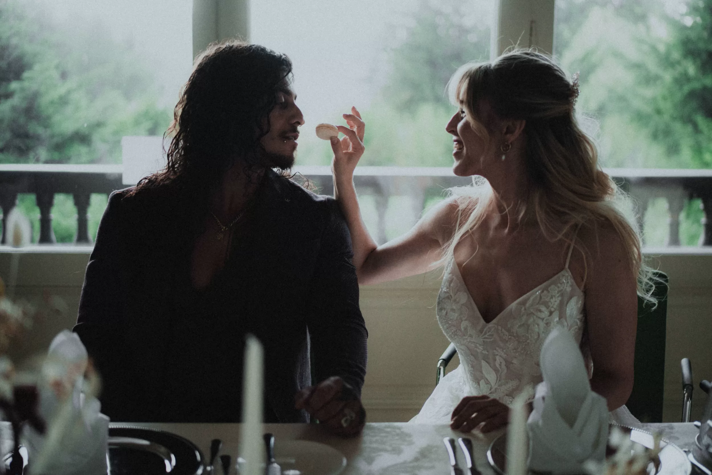 Wedding photoshoot by Fedor Vasilev, a couple at a wedding table in a villa in Alps