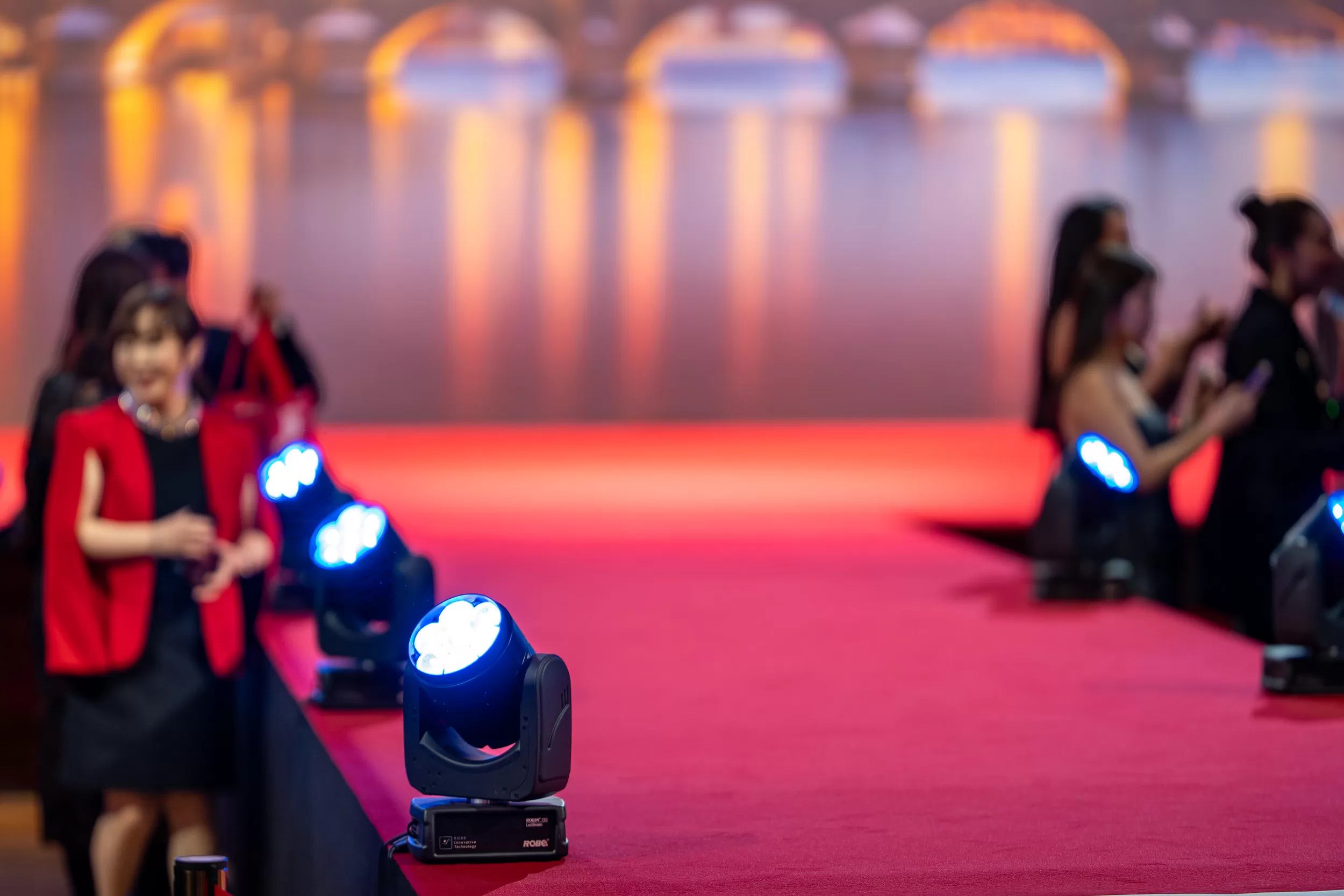 The red carpet leading to a stage at an event