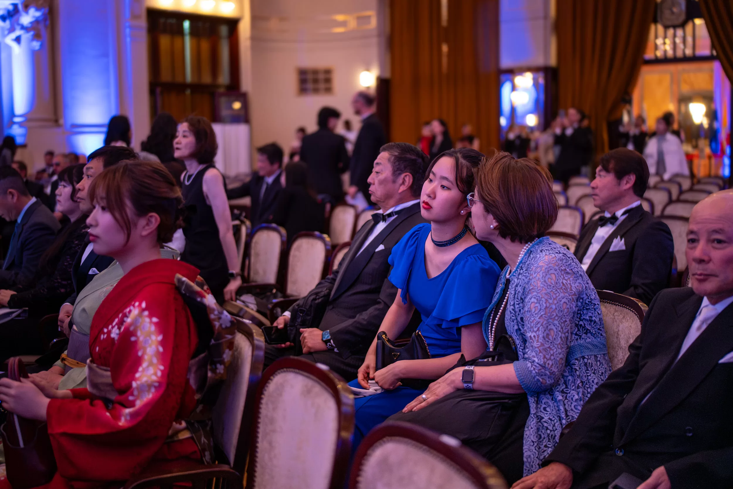 Audience and participants of an award ceremony at their rows