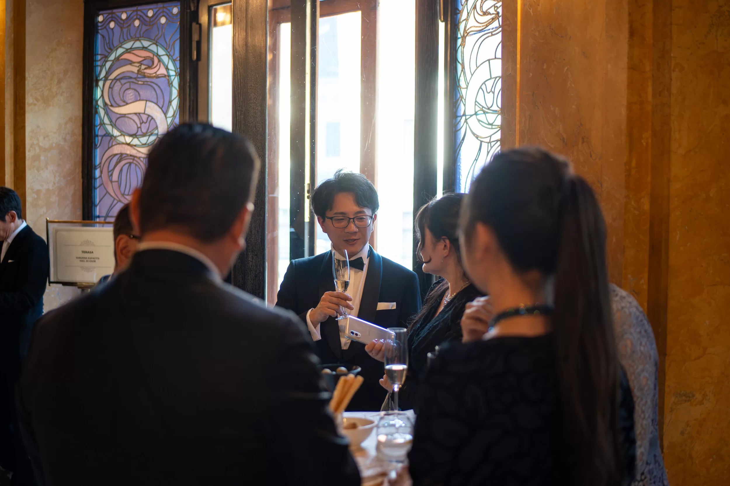 People socialising during an event reception in an old concert house
