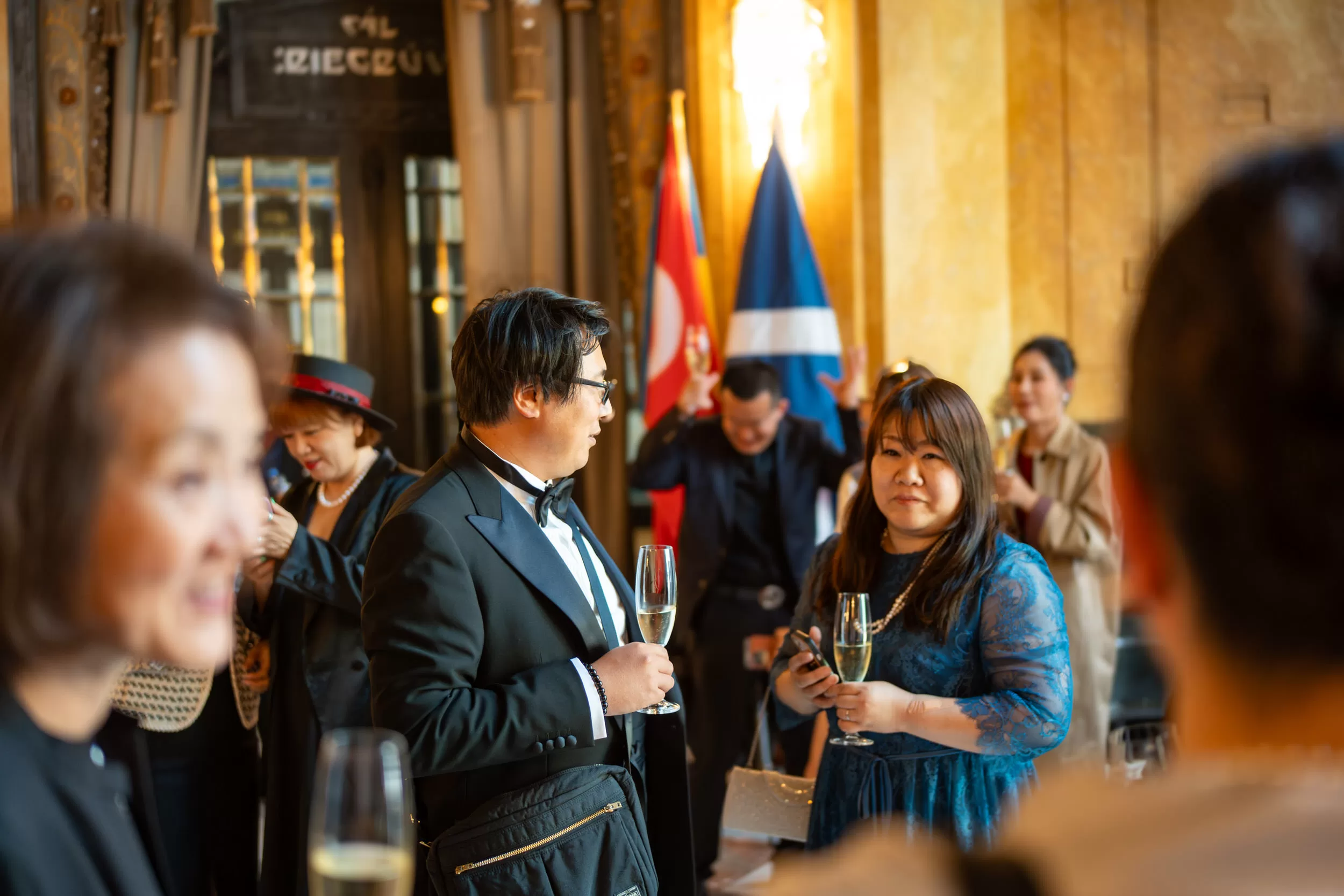 People drinking sparkling wine on an event reception