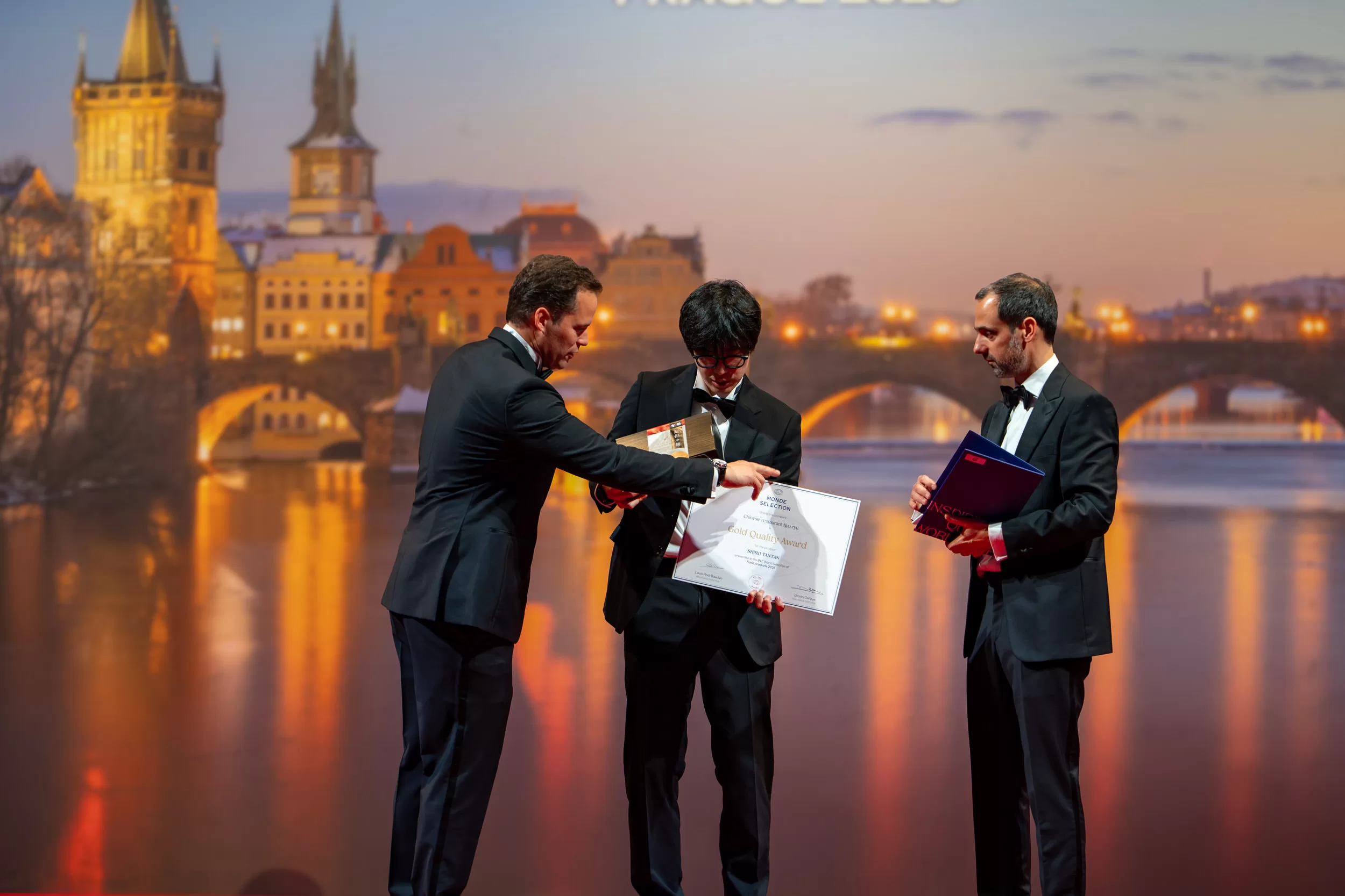 A young man receiving an award on a stage