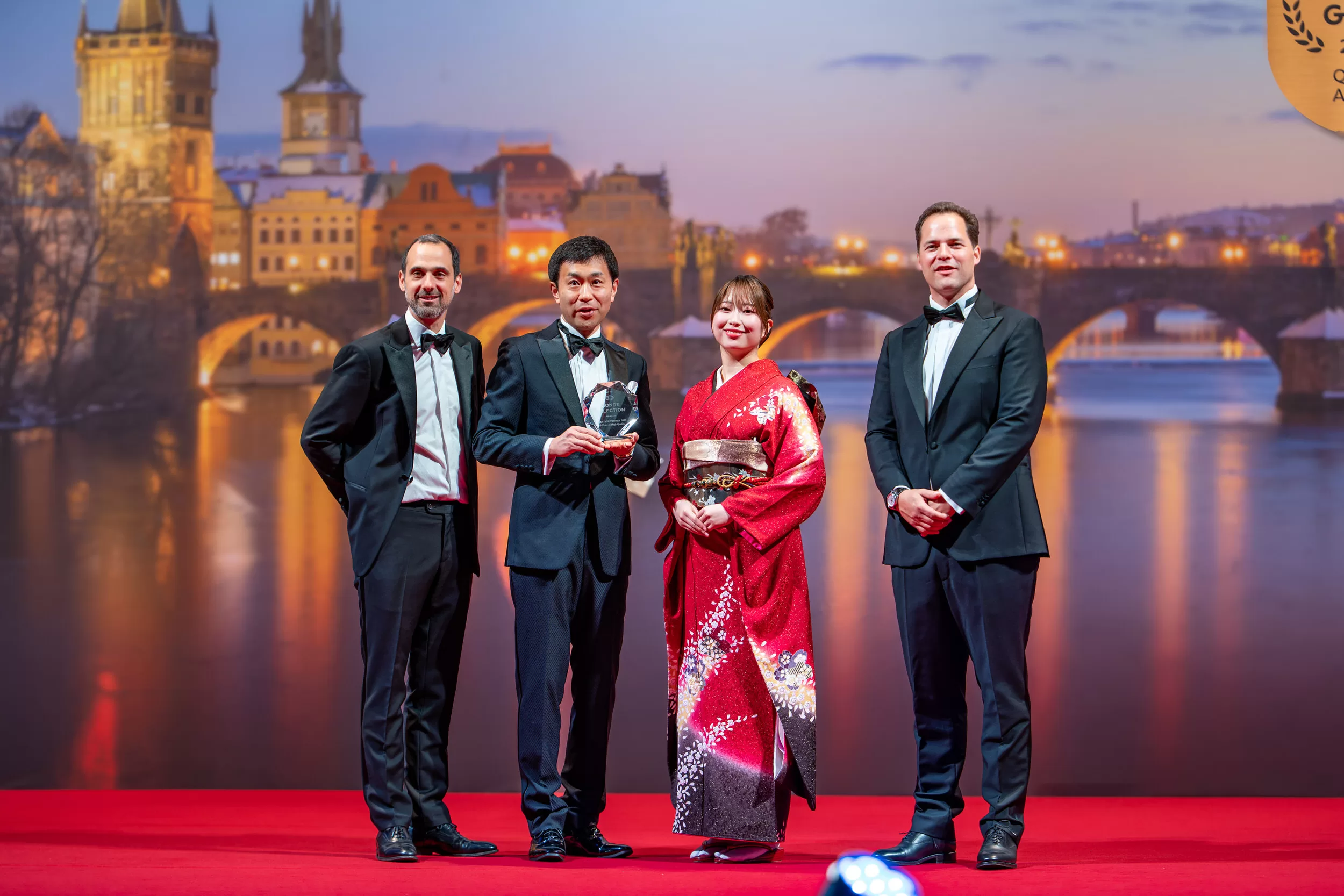 Winners of an award ceremony on a stage with red carpet
