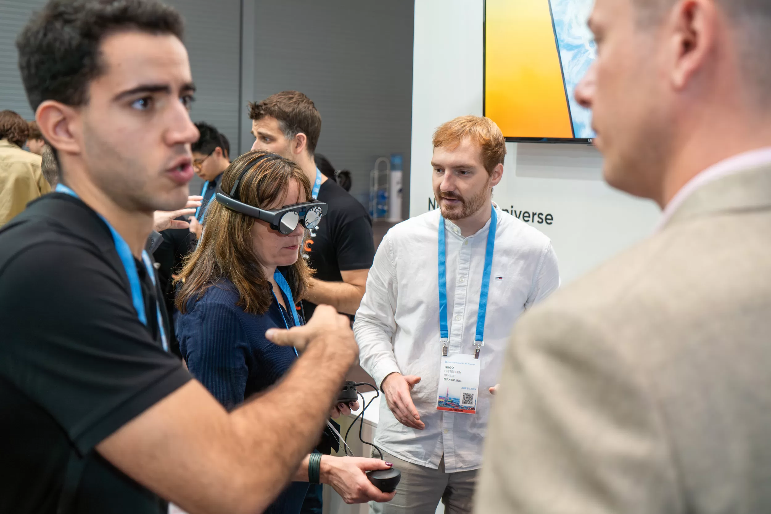 People discussing new products on a tech trade fair