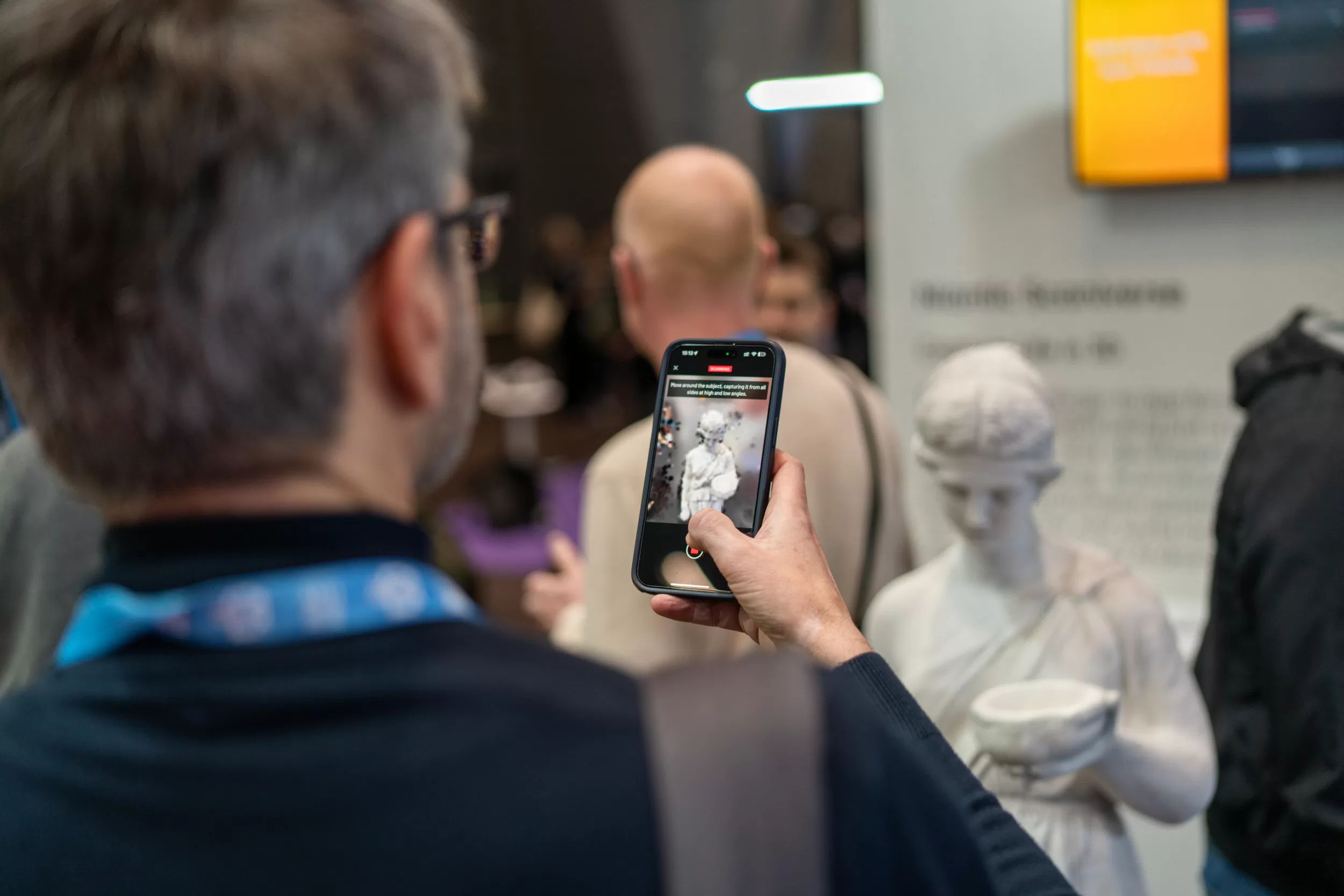 Person scanning a statue at a tech expo