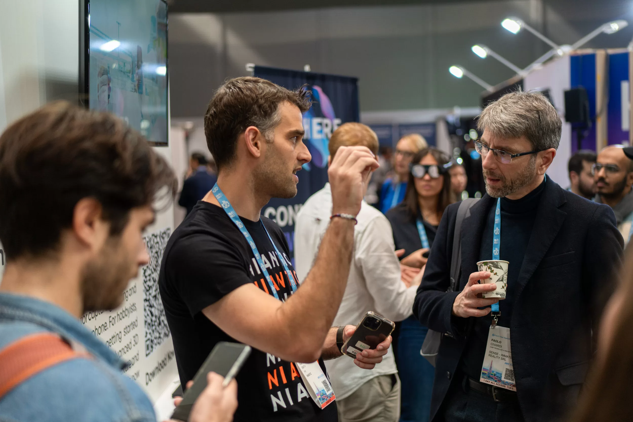 People networking in a tech booth on an event