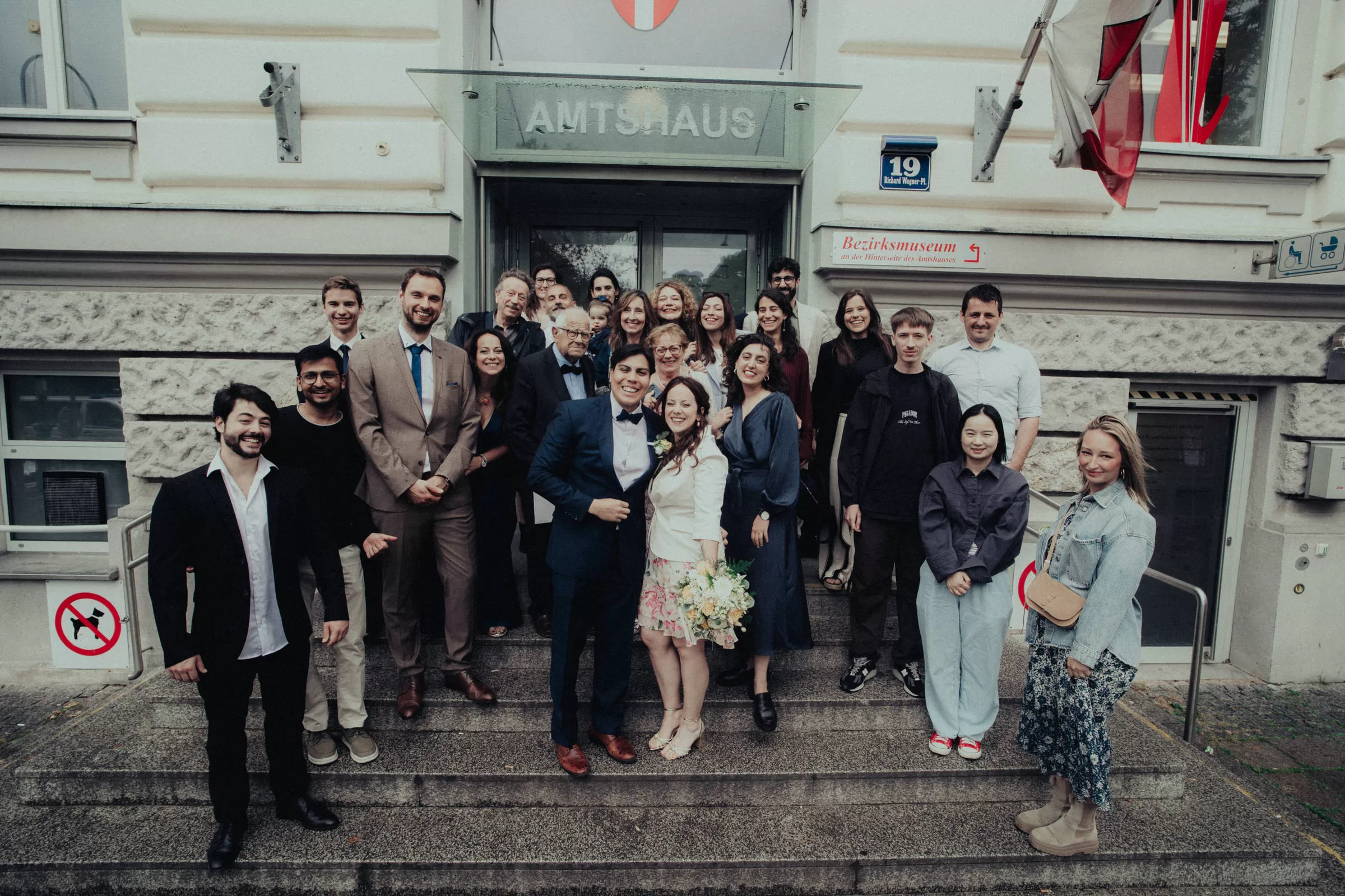 Group photo of guests with newlyweds after a wedding ceremony
