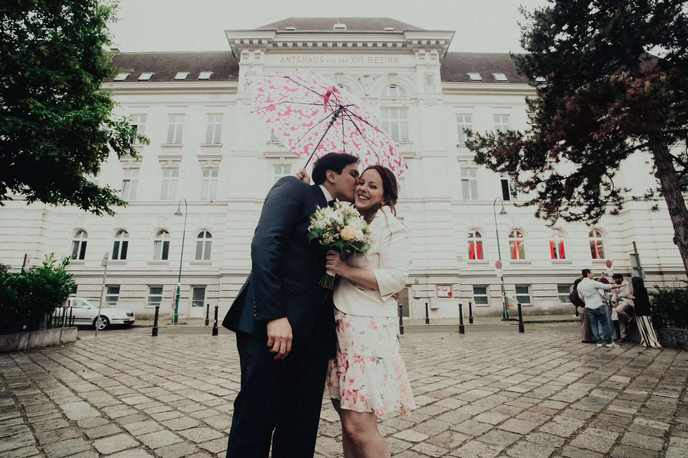 A couple on a square in front of registry office on their wedding day