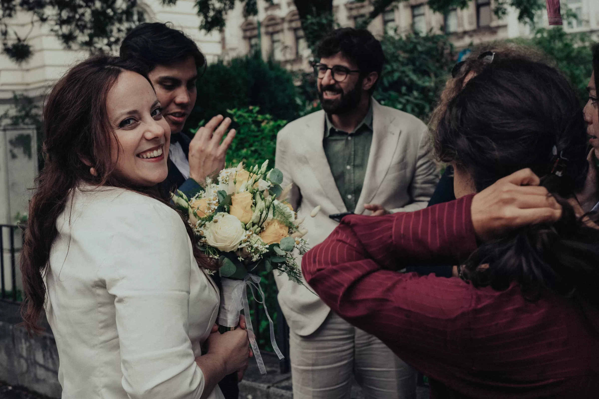 Bride and wedding guests chatting outside the registry office