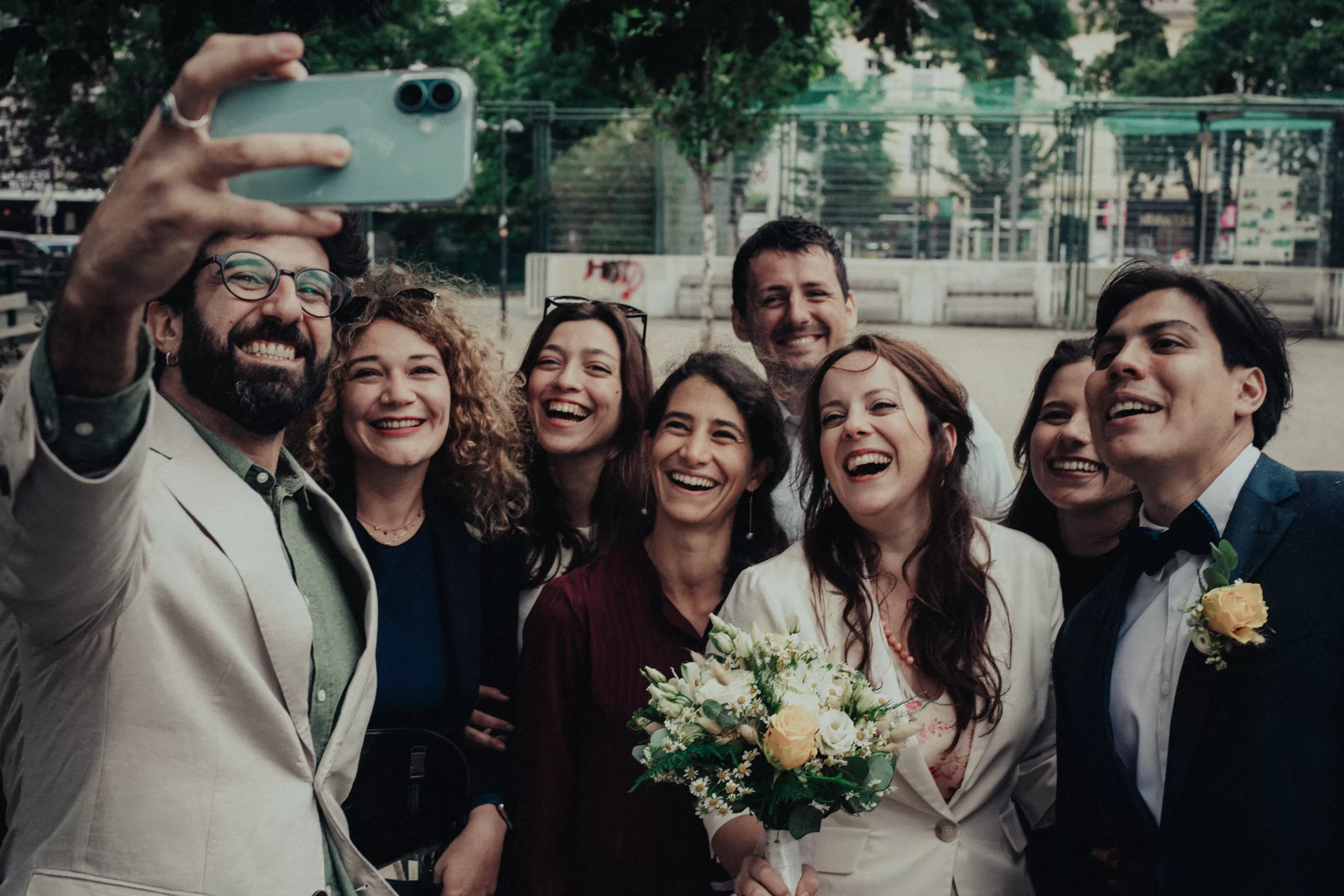 Wedding guests taking selfie outside
