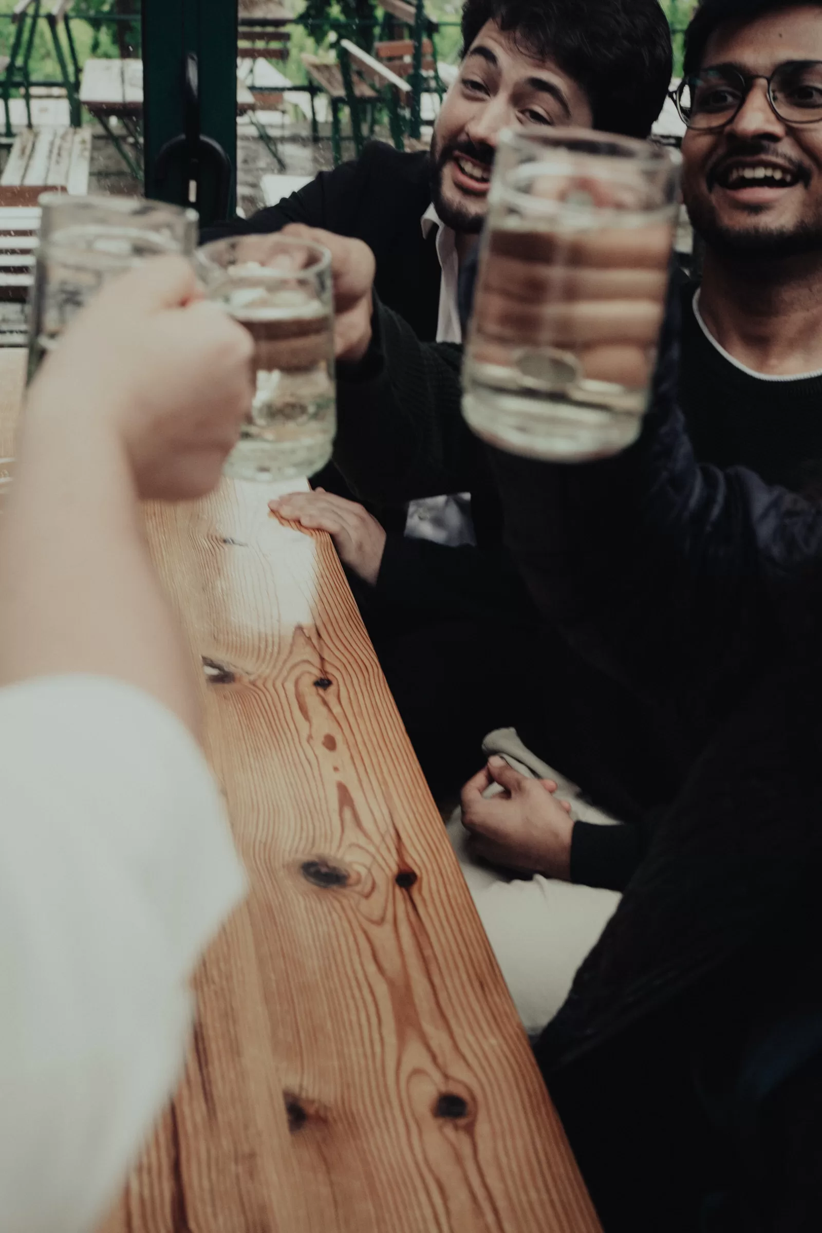 Guests rise cups with wine during a wedding celebration at a vineyard in vienna