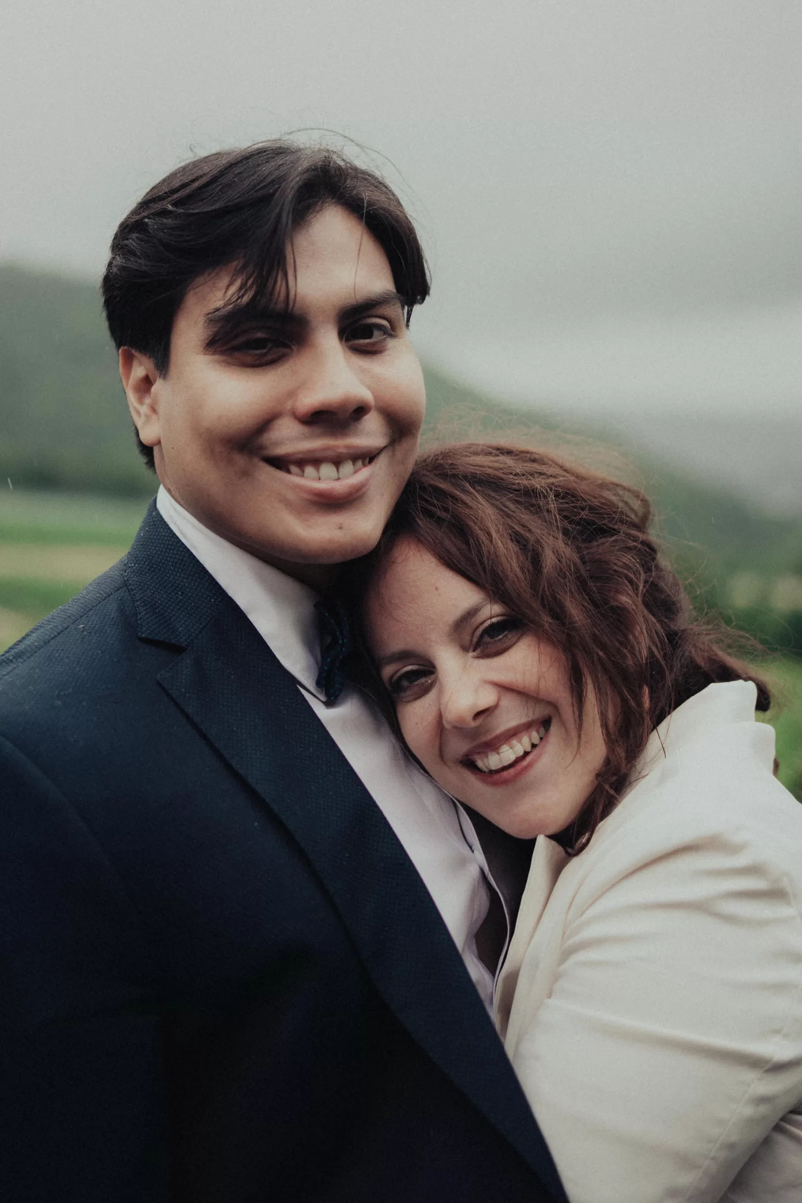 romantic wedding photoshoot on viennese hills. a portait of a couple hugging on a rainy day