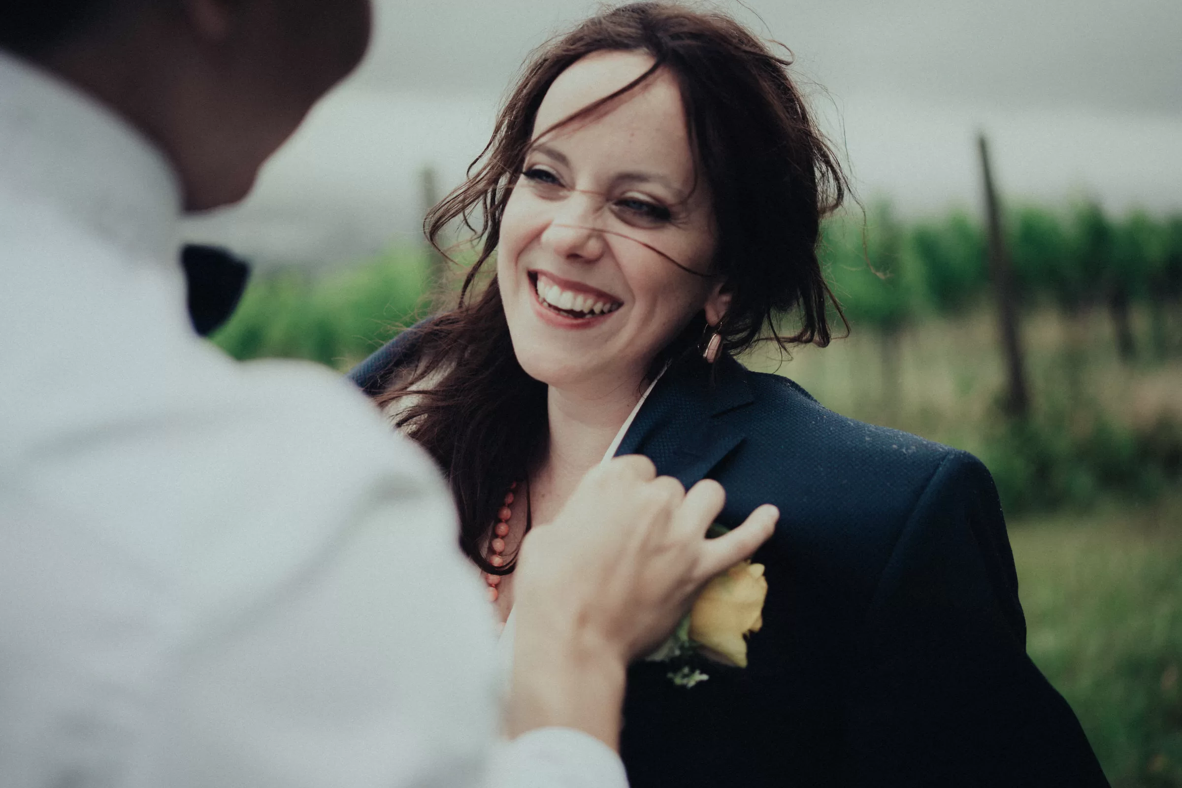 bride looking at groom smiling on a rainy day at a vineyard near vienna