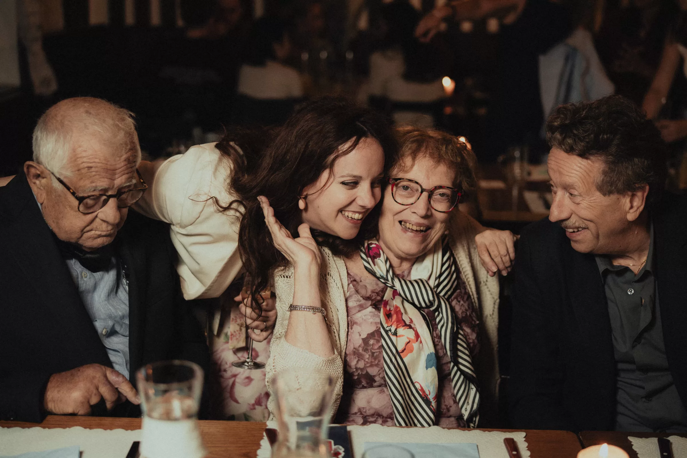 Bride with her parents in a restaurant on the wedding day