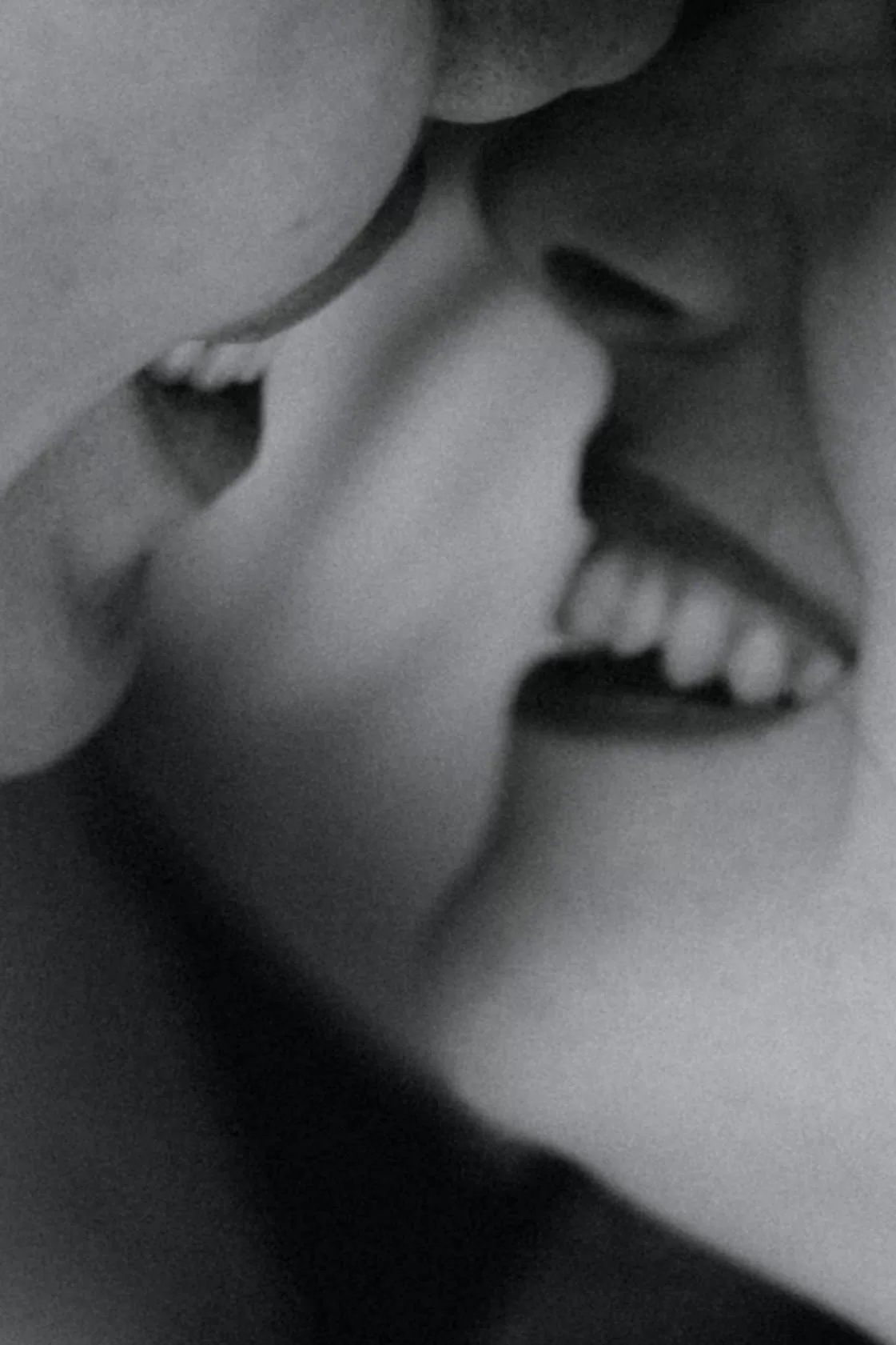 Black and white closeup photo of a couple nearly kissing
