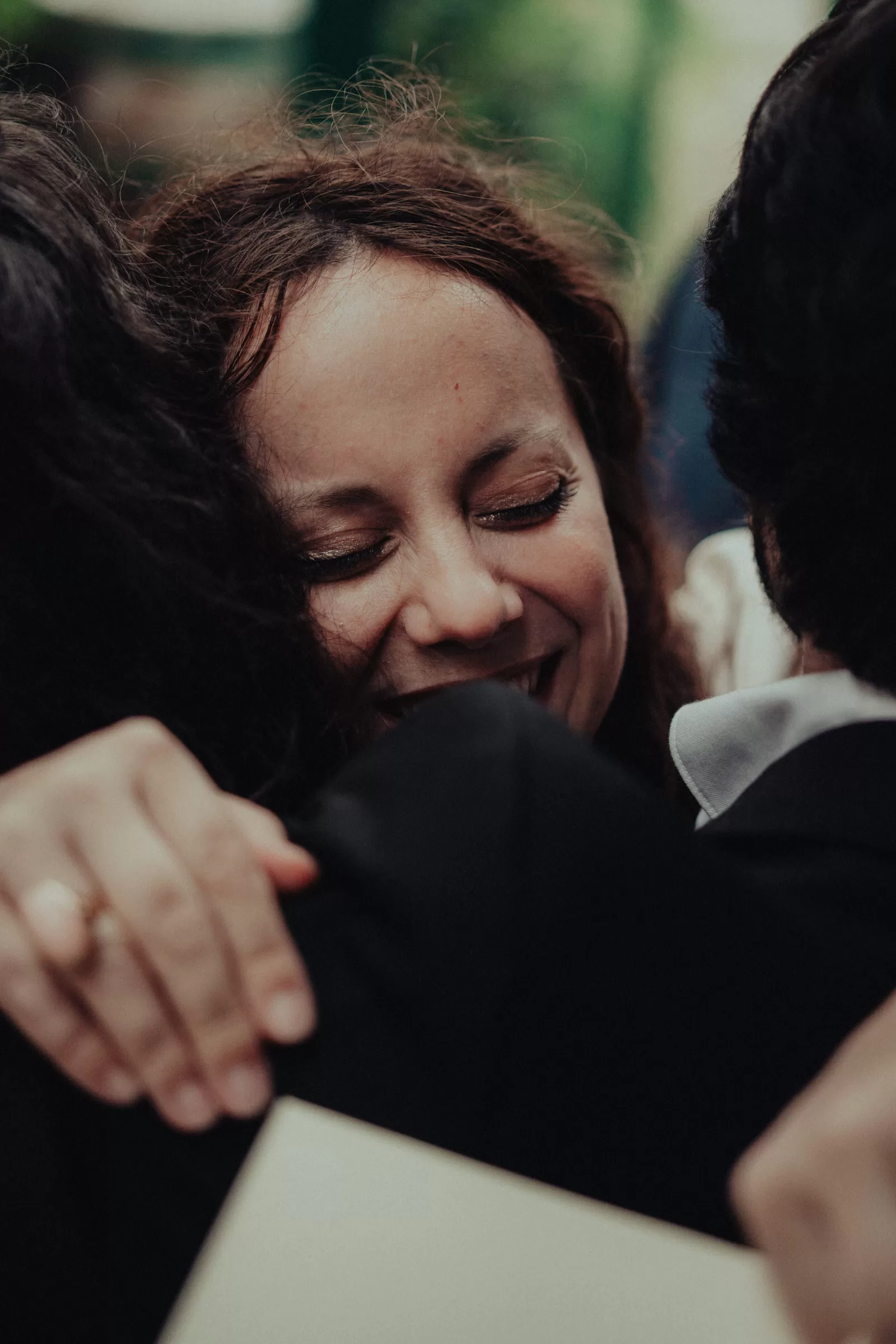 Bride hugging with guests on her wedding at a heuriger in vienna