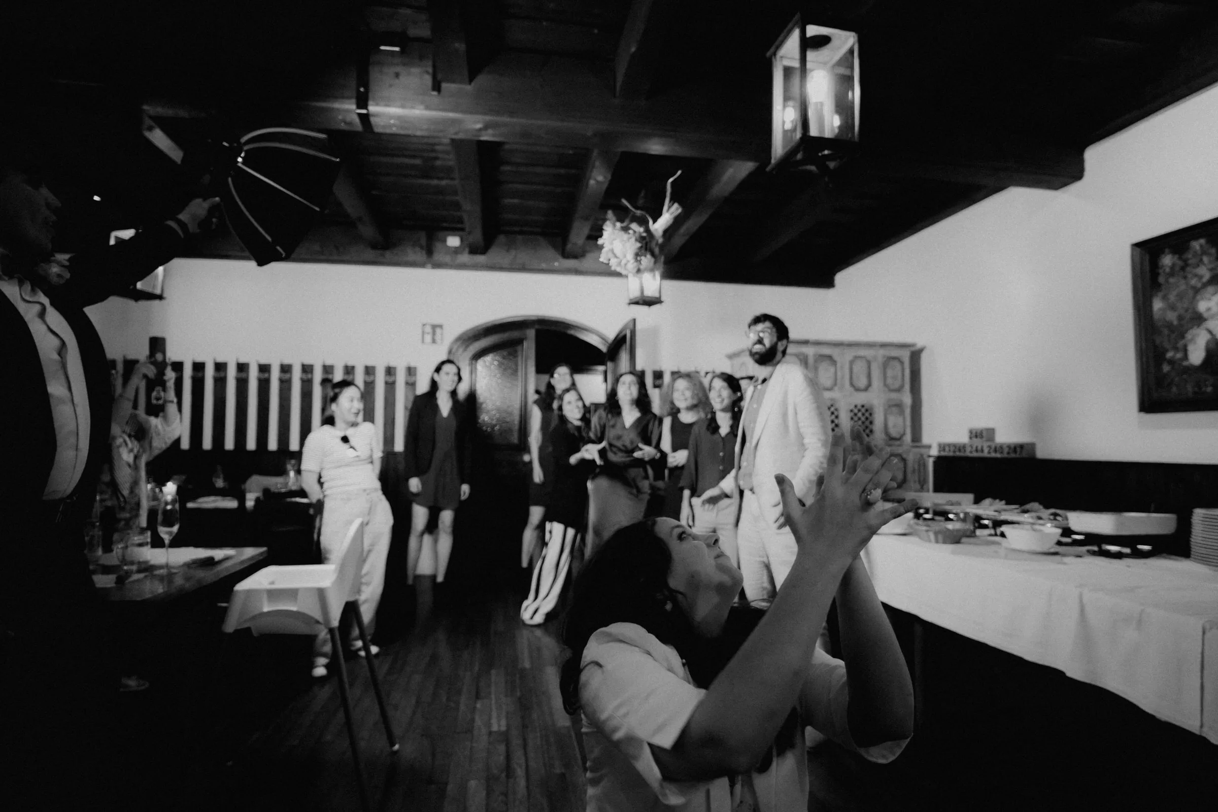 bouquet throw at a wedding in a classic viennese restaurant a black and white photo