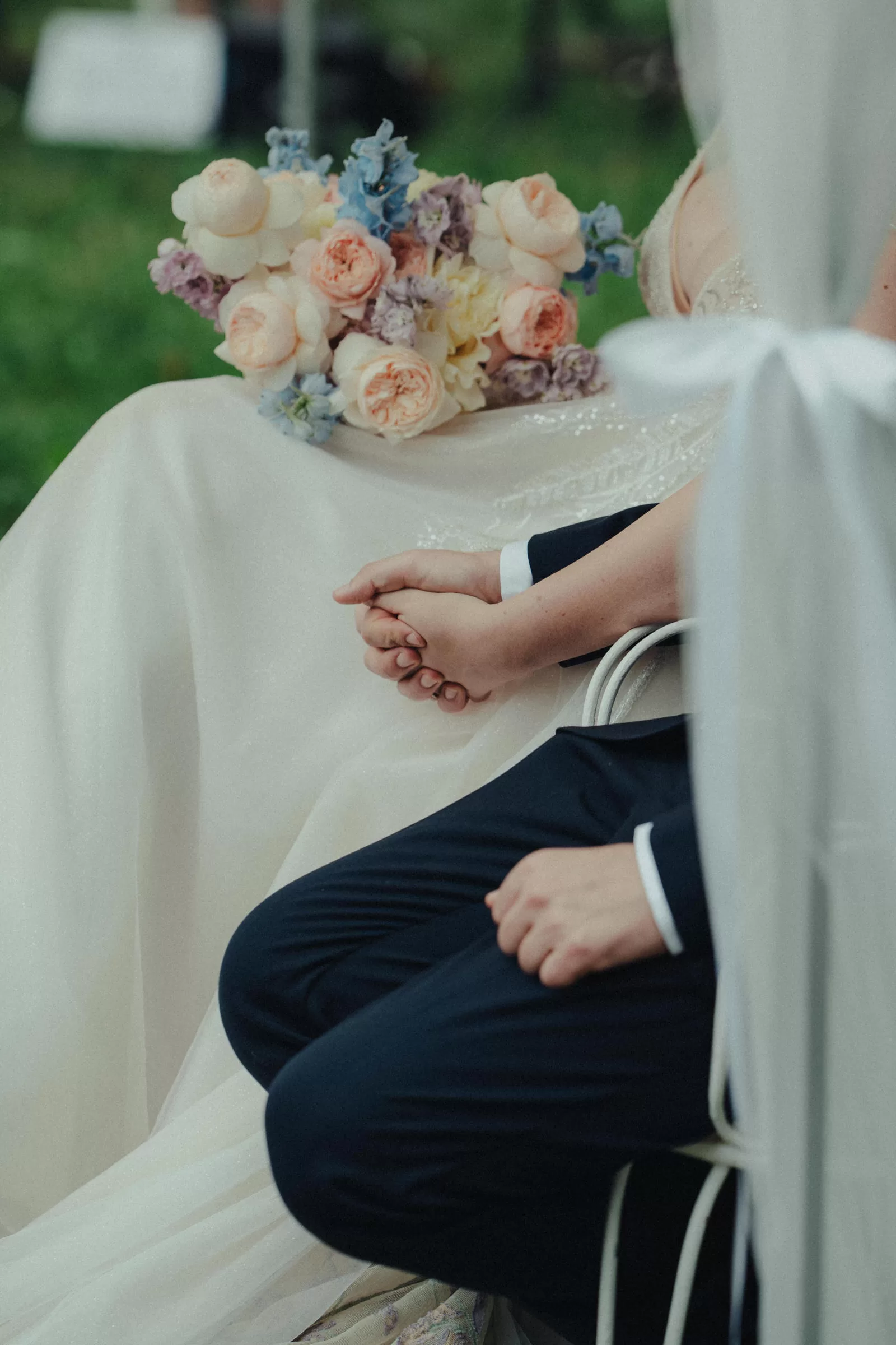 Couple holding hands during their garden wedding ceremony