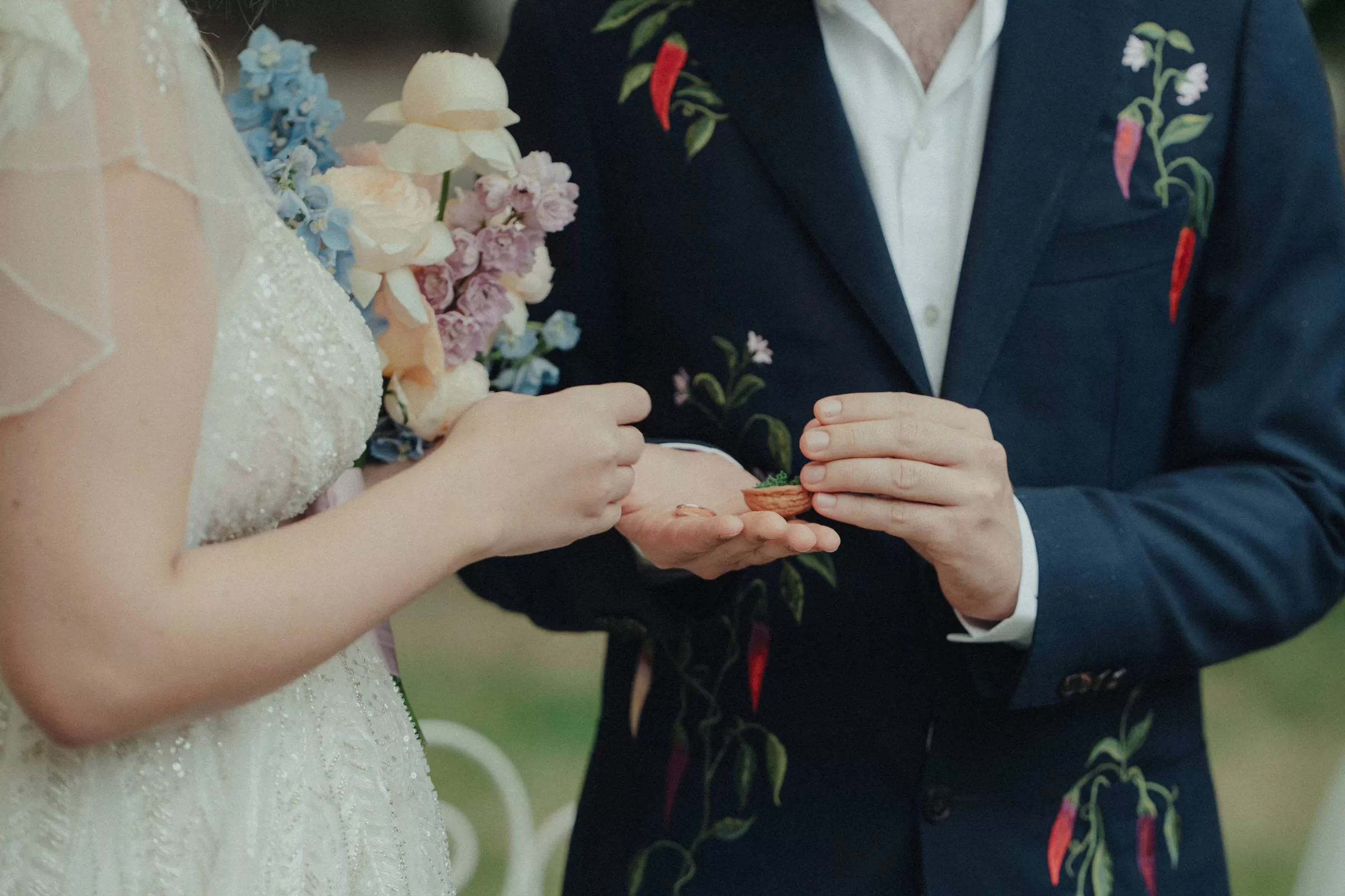 A groom is giving a ring to his bride on a wedding ceremony
