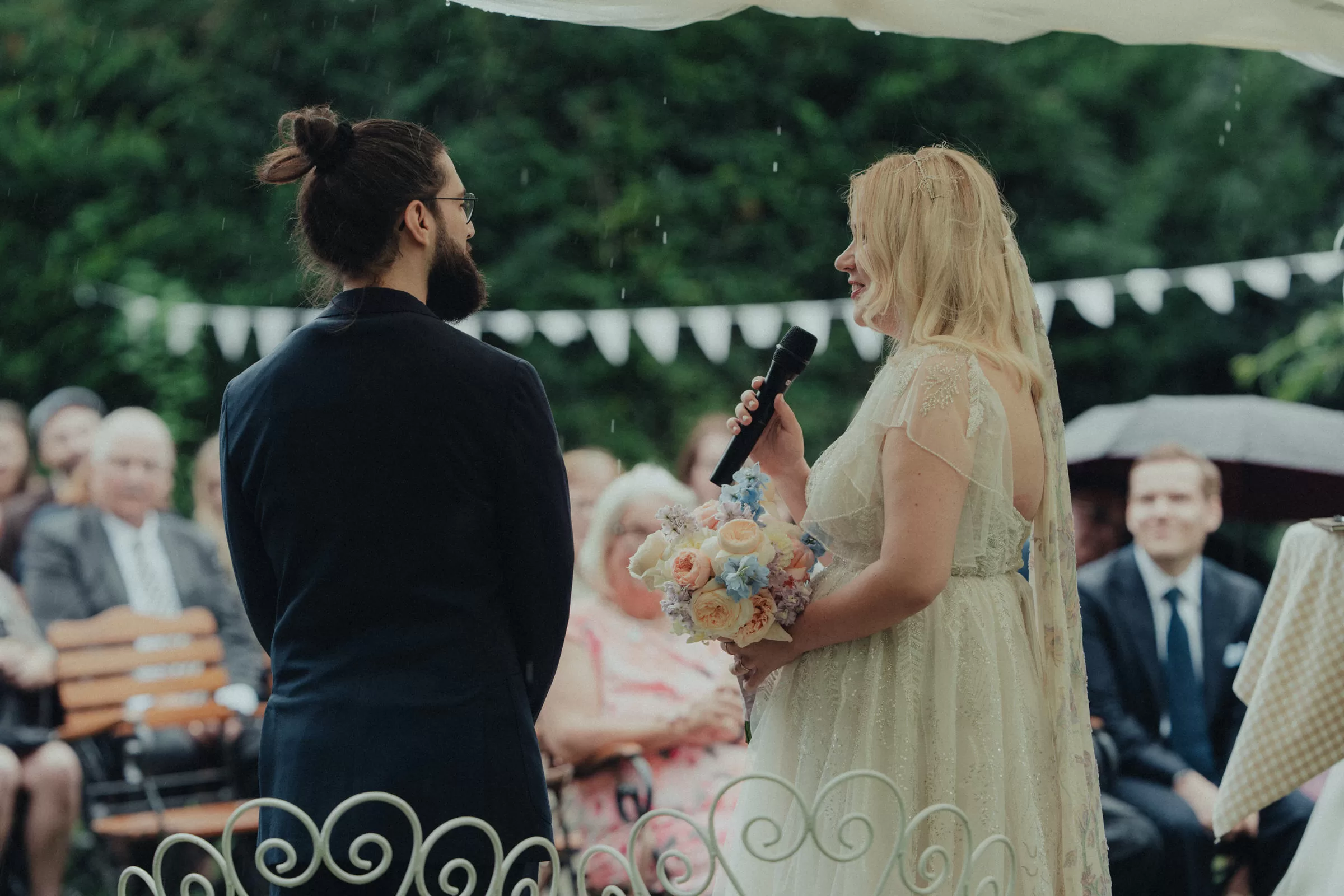 Groom and bride with a microphone on their wedding ceremony