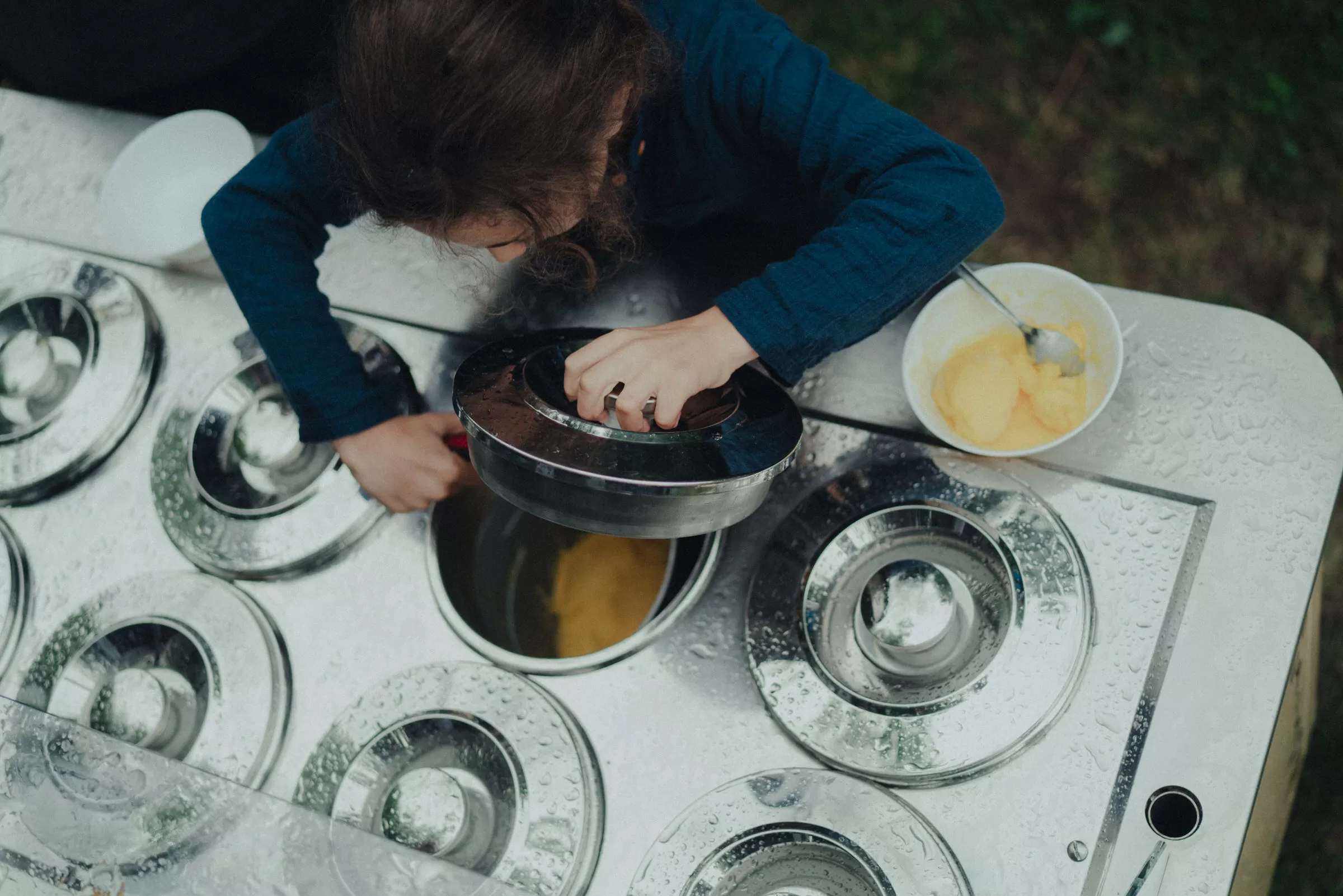 Child taking icecream from a trolley