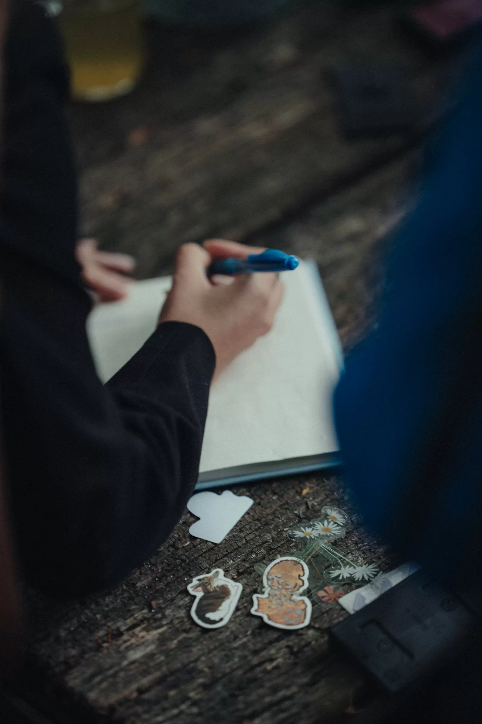 people writing wishes on a wedding notebook