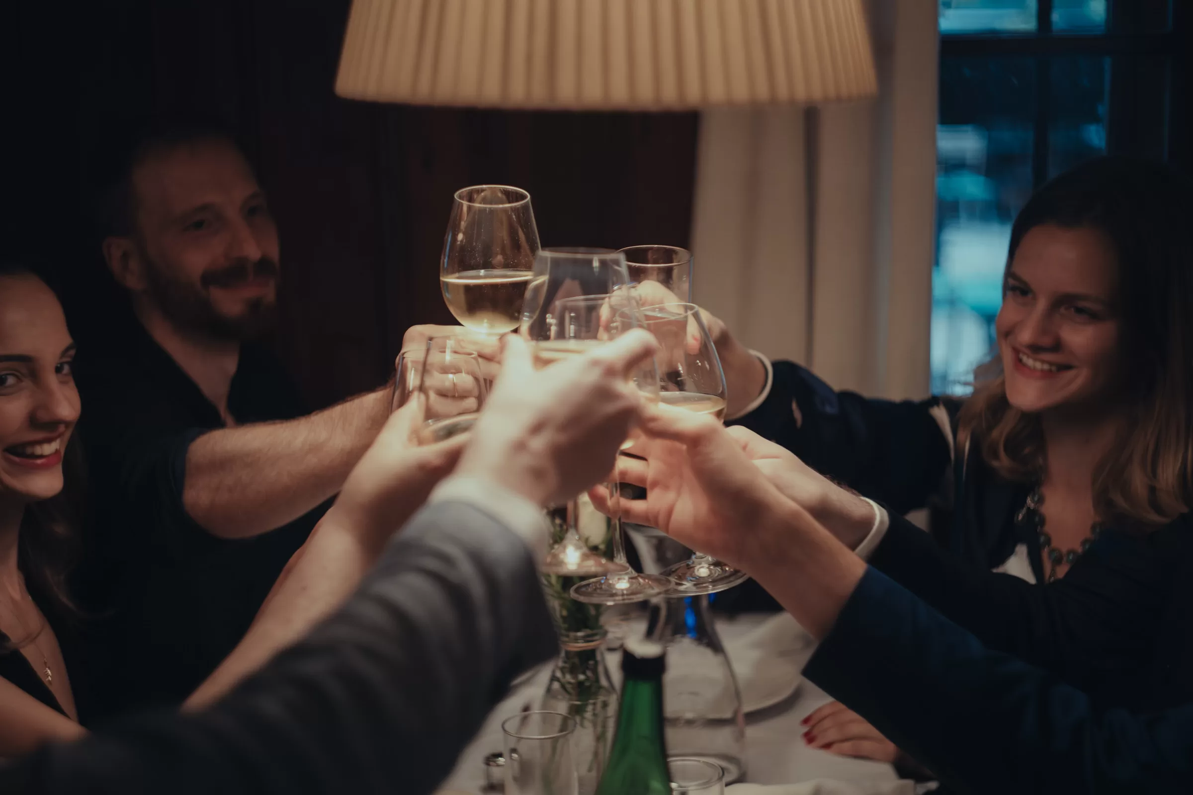 people clinking glasses in a wedding venue at a heuriger in Vienna