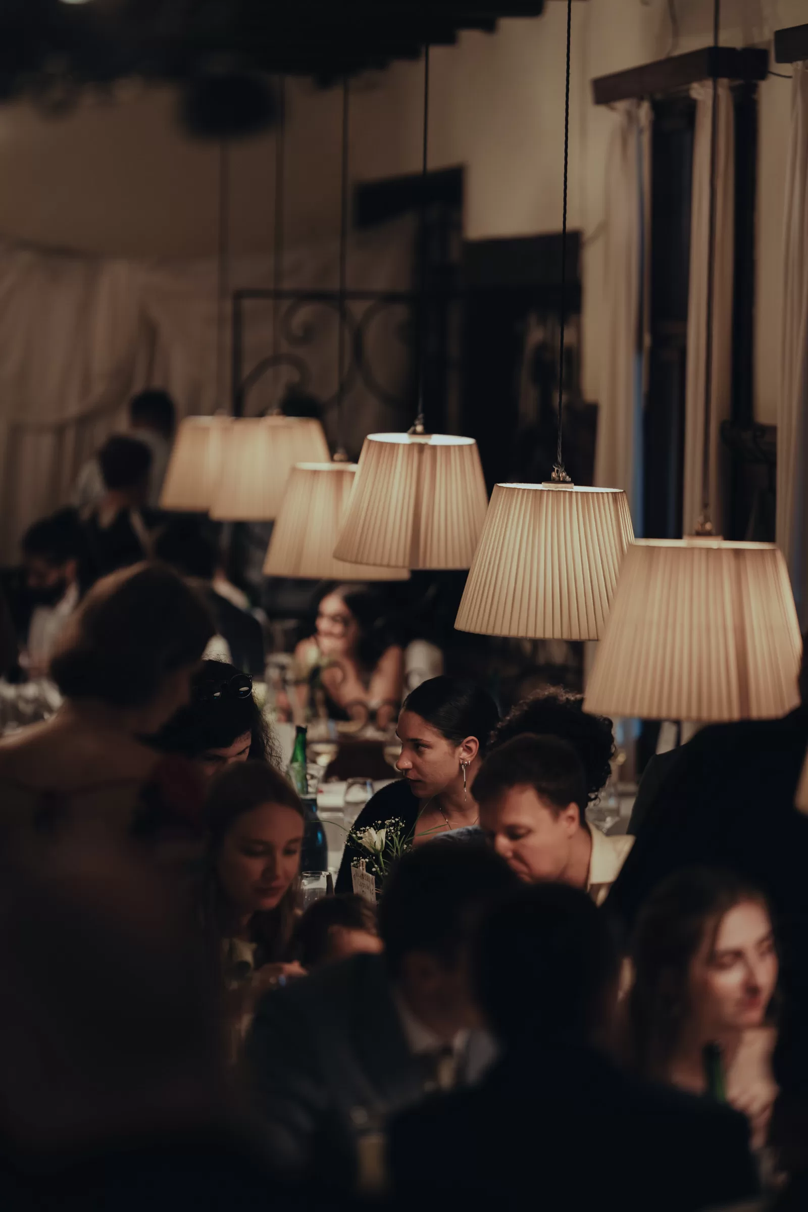 People sitting at tables at a wedding venue
