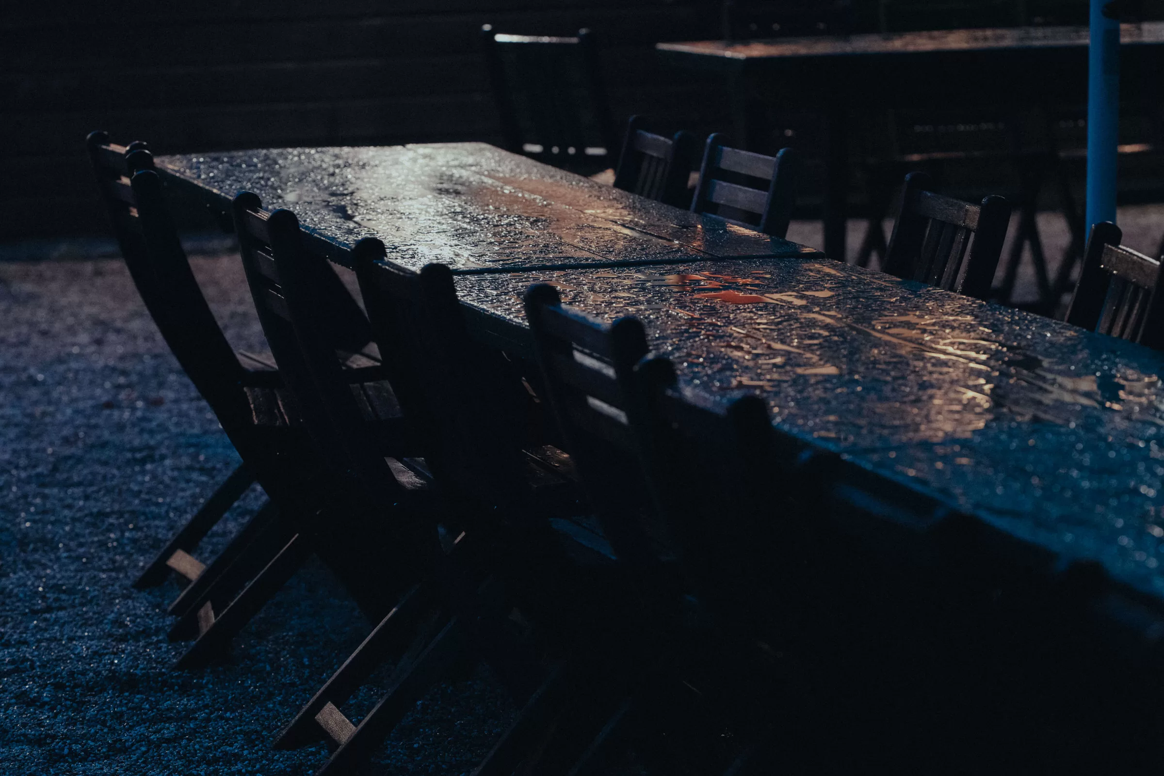 wet tables outside a wedding venue on a rainy evening