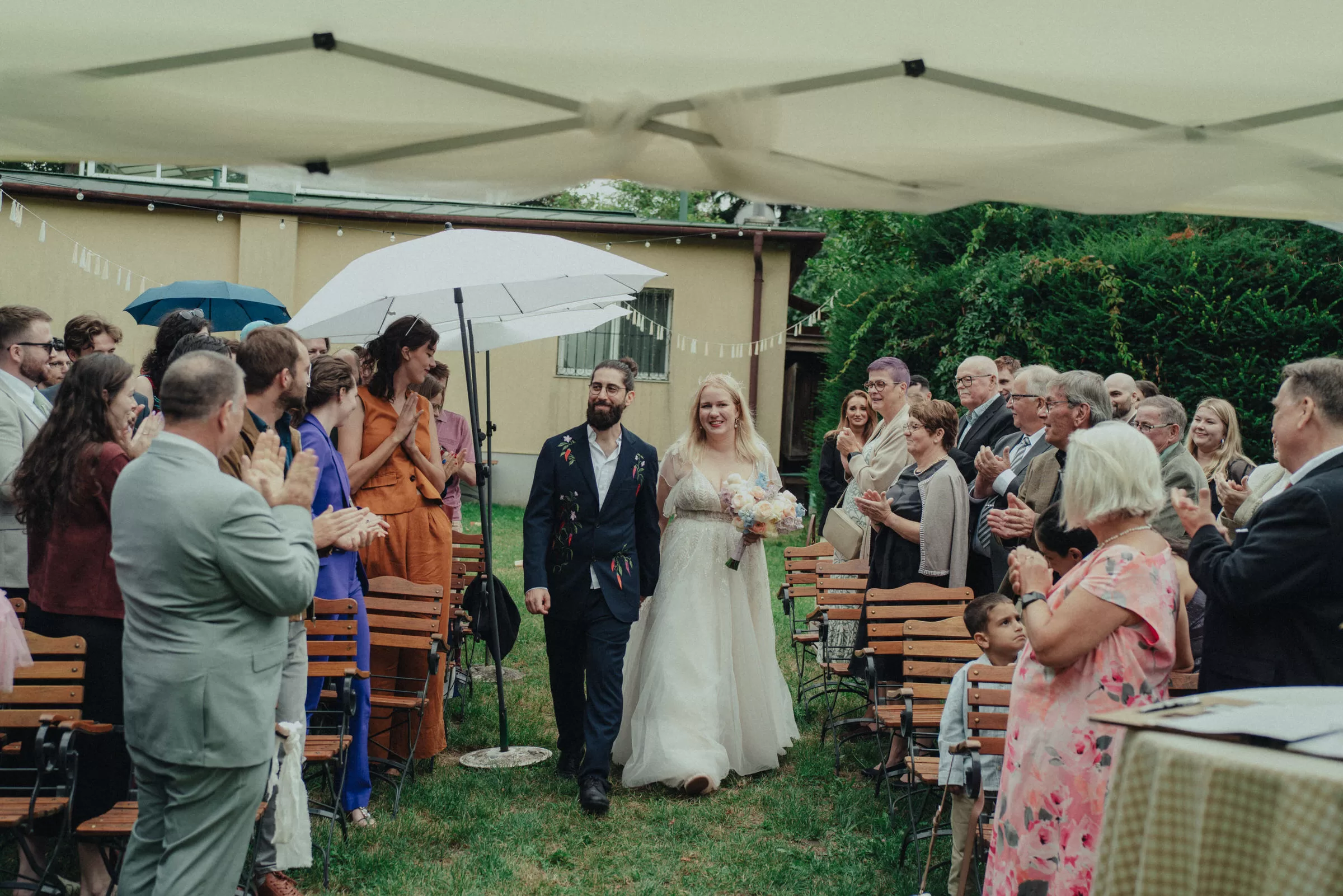 newlyweds walk between the isles with guests of the wedding during their wedding ceremony in vienna