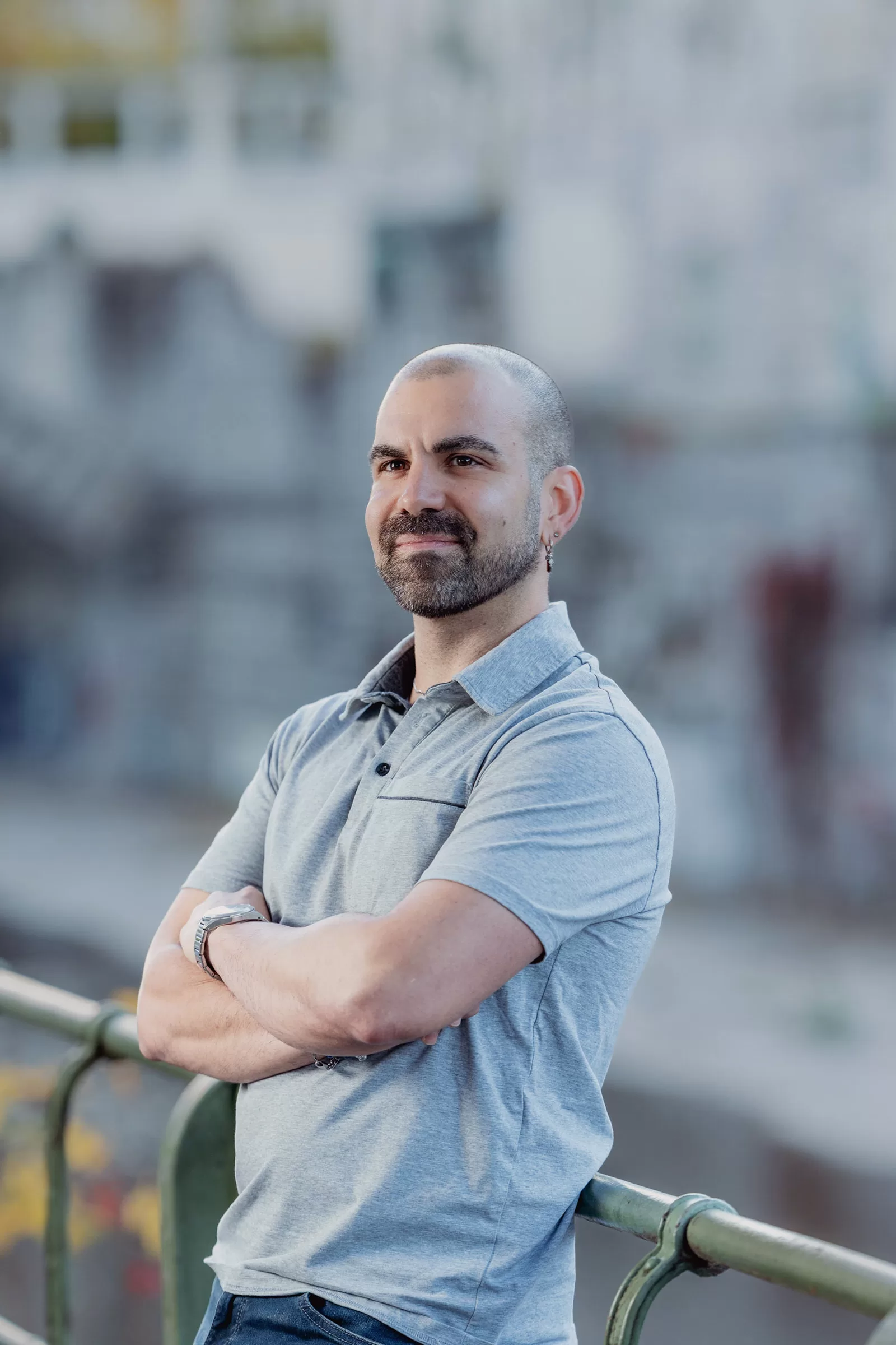 Portrait of a man leaning on railing next to a river in Stadtpark, Vienna
