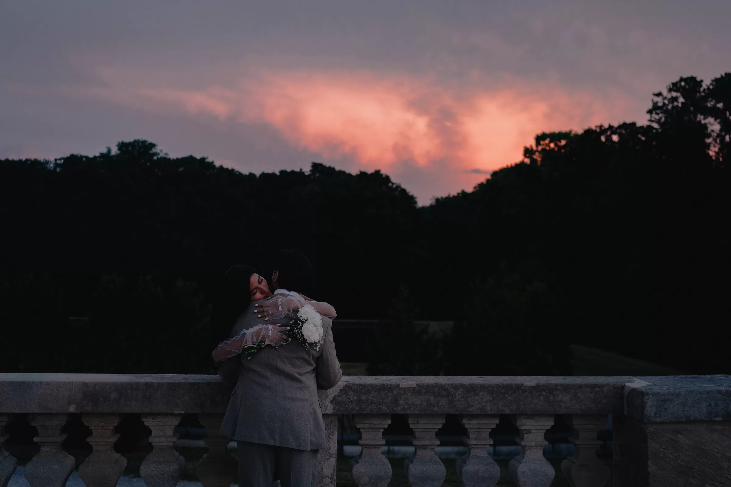 Photo of a couple having an intimate moment with a dramatic sky
