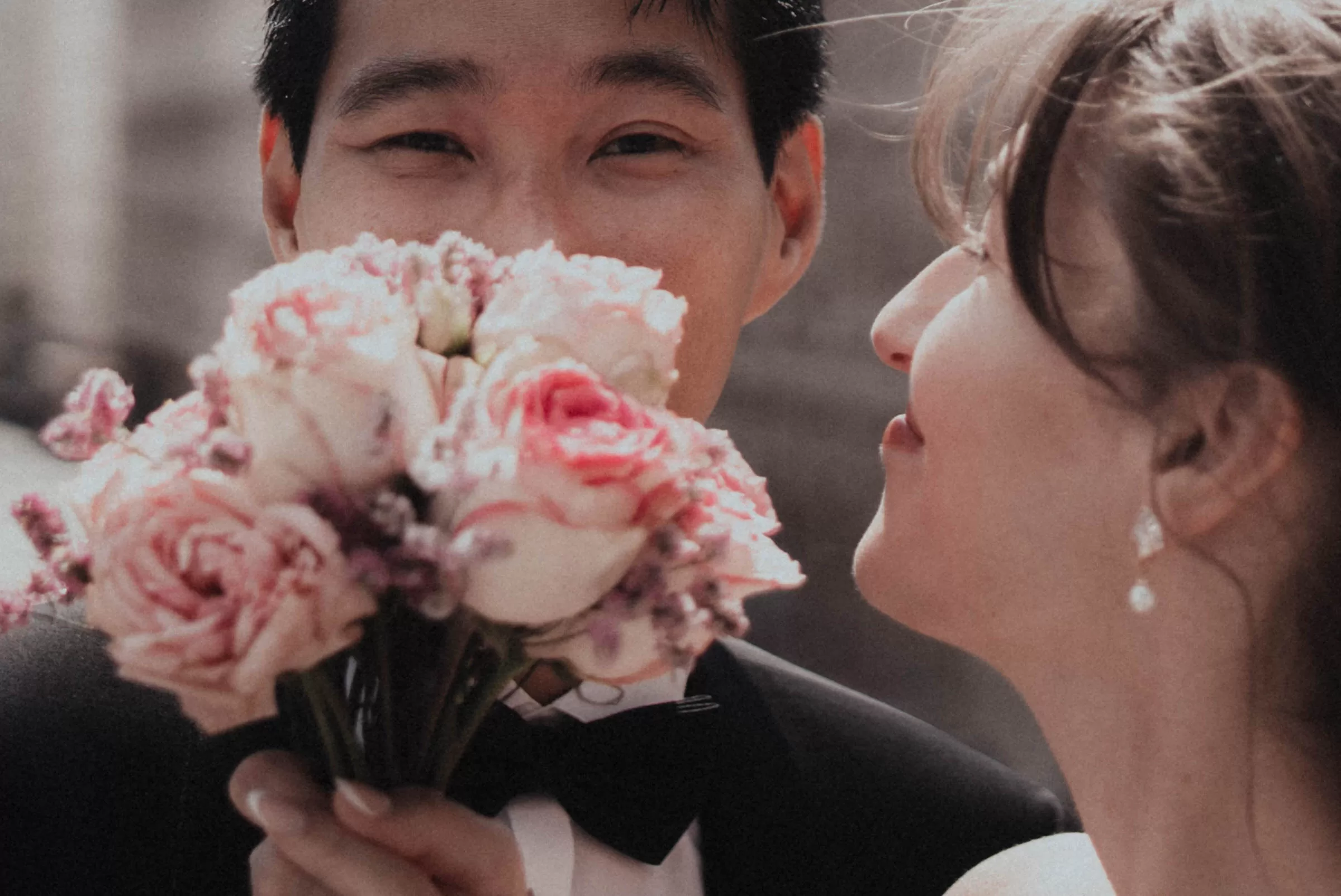 Portrait of groom and bride with a bouquet of flowers 