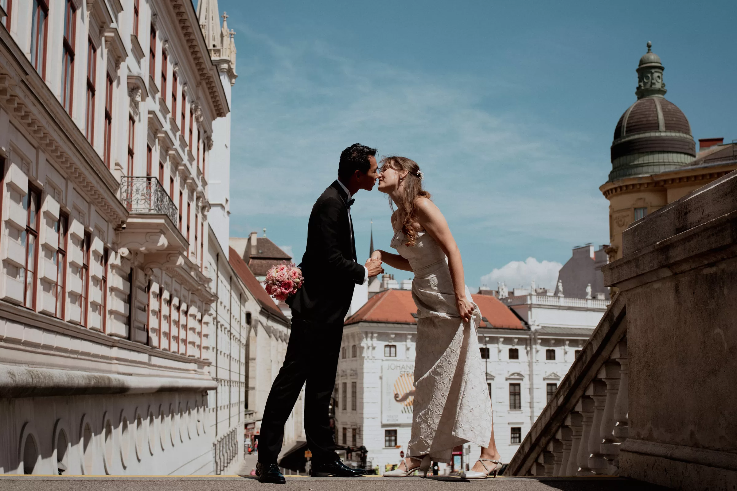 Couple photo on a terrace in vienna with rooftops of other houses on the background