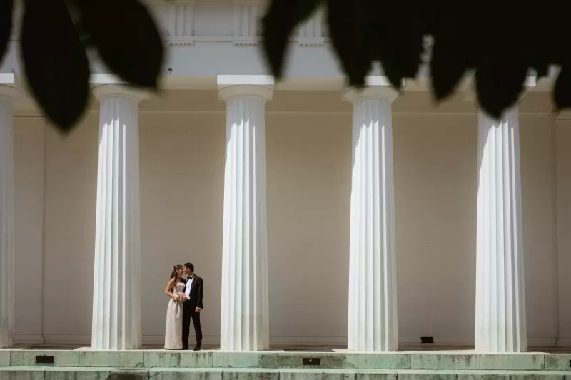 Elegant couple between columns of Theseus Temple in Vienna